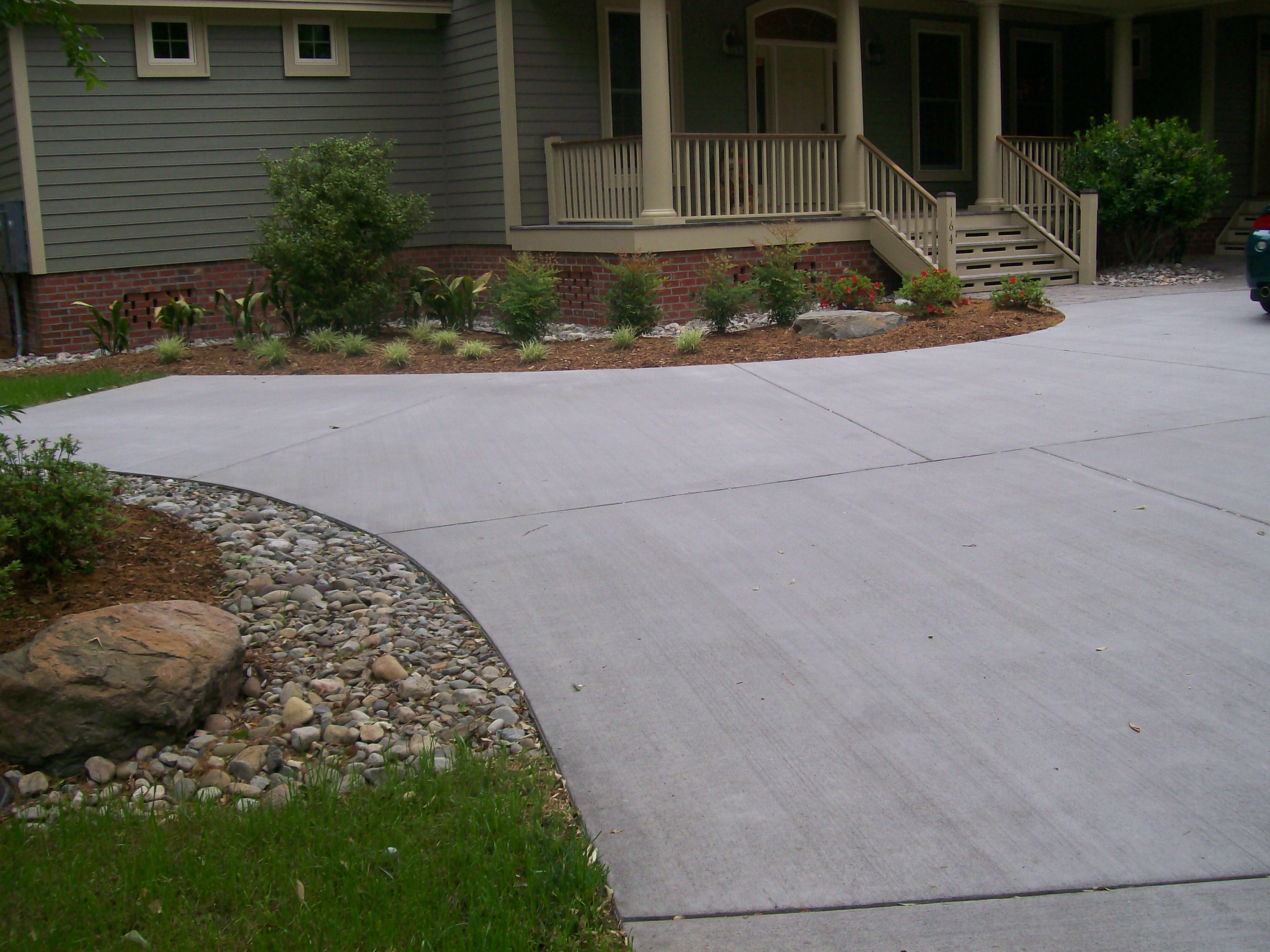 Concrete Stamped Border Driveway With Broom Finish Interior.