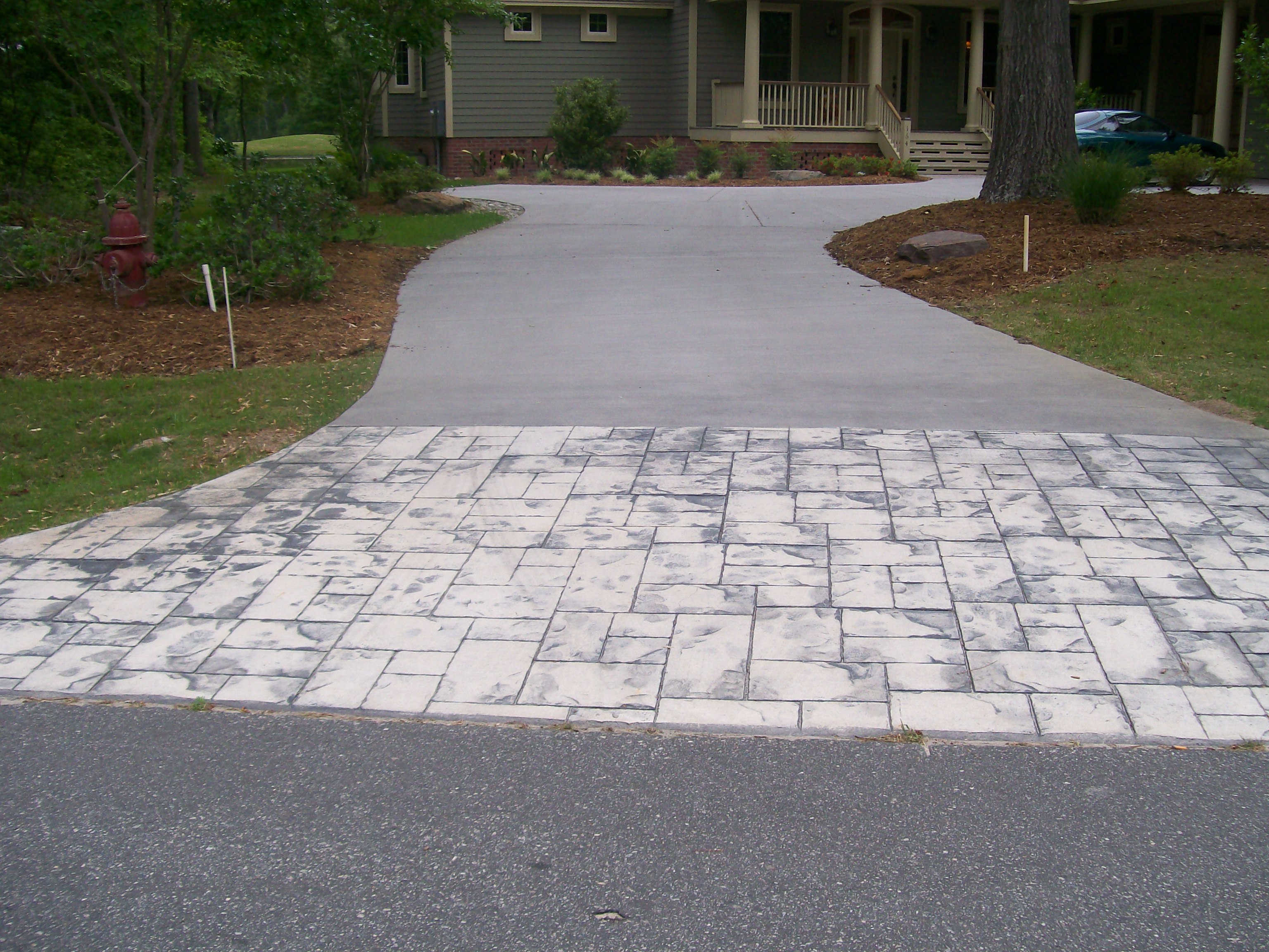 Concrete Stamped Border Driveway With Broom Finish Interior.