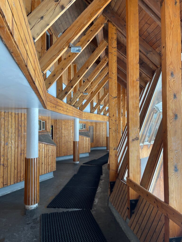 Impressive wooden interior of one of the buildings in Avoriaz 1800, ceiling beams at 45° angles and lots of wooden wall panelling.