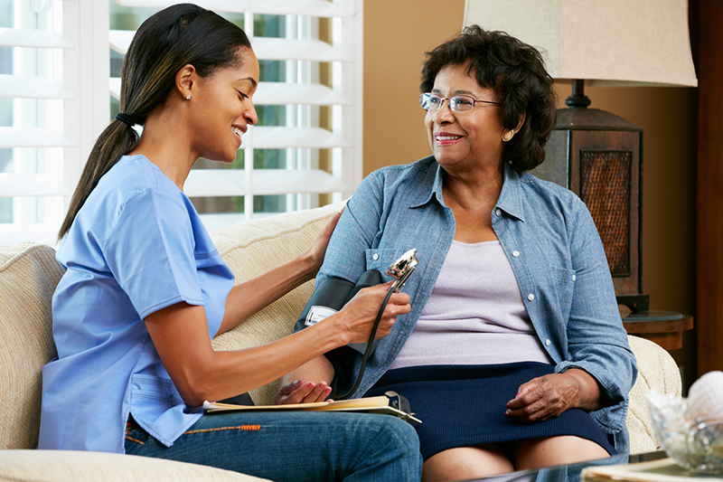 Nurse Visiting Senior Female Patient At Home Heritage Health Care