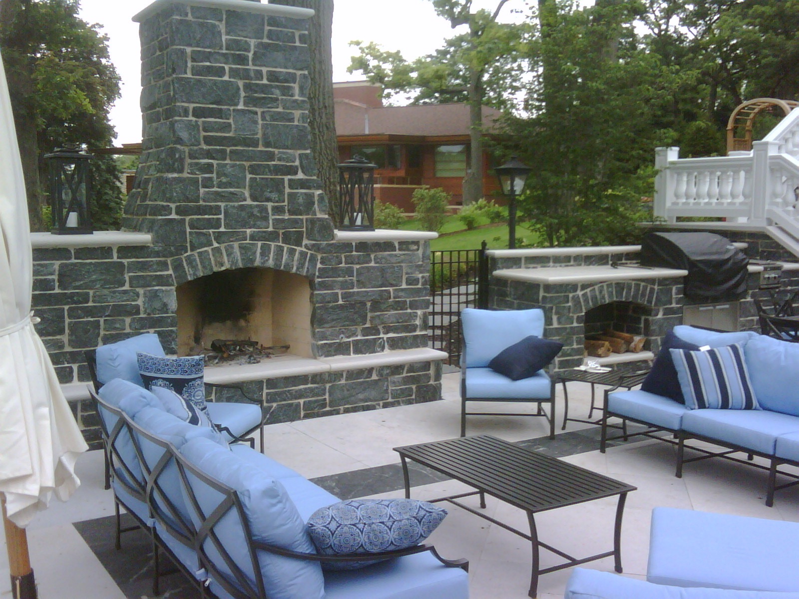 Aqua grantique stone veneer fireplace with bullnosed Indiana limestone coping Hirsch Brick and
