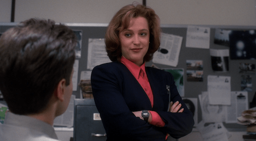 Scully smirks at Mulder.