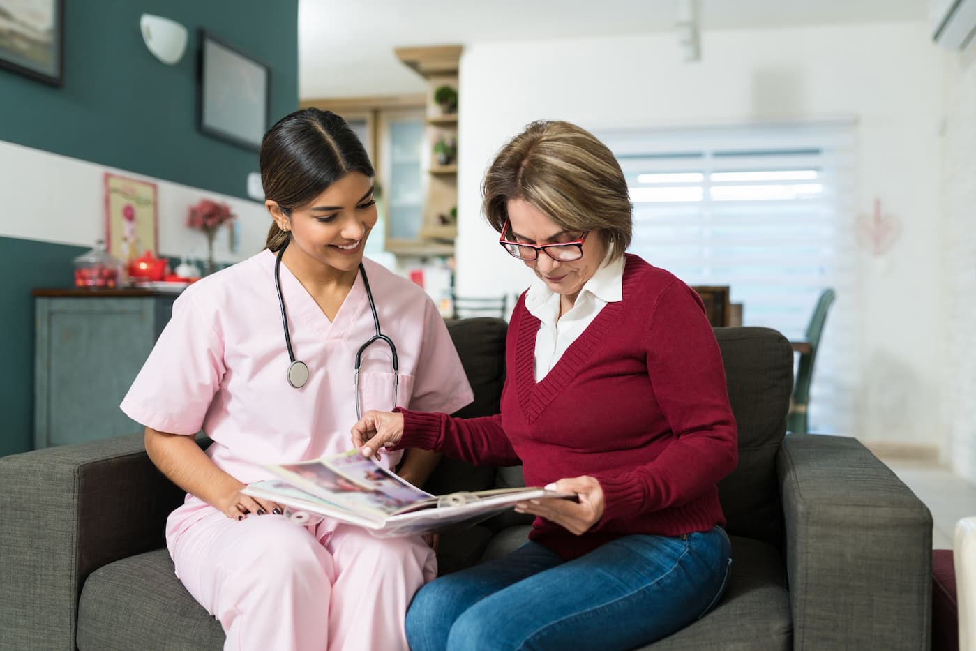 A woman sits with a medical professional while choosing an inhome care