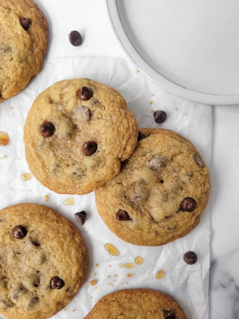 maple chocolate chip cookies on top of a parchment paper