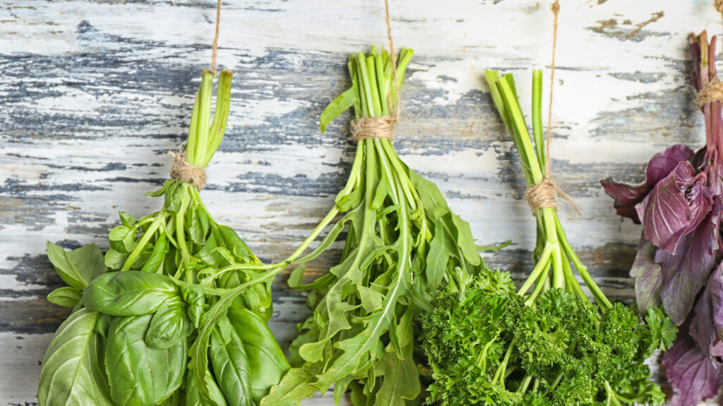Bunches of different herbs on wooden background