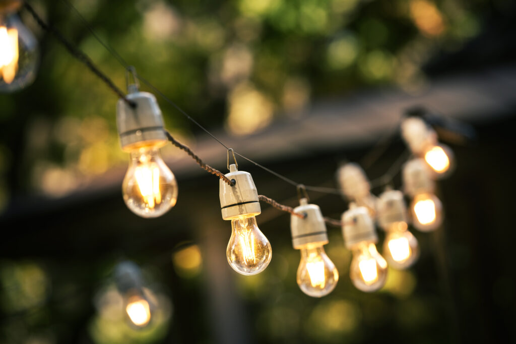 outdoor string lights hanging on a line in backyard