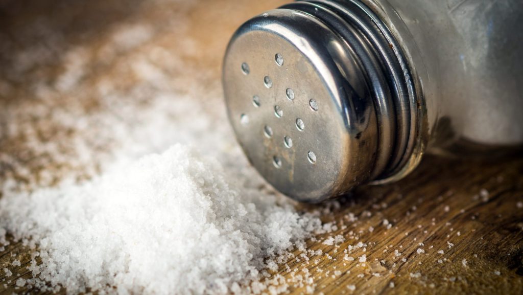 Salt on wooden background