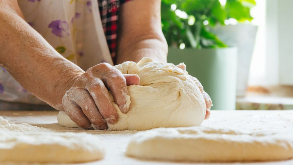 homemaker rolling dough from scratch