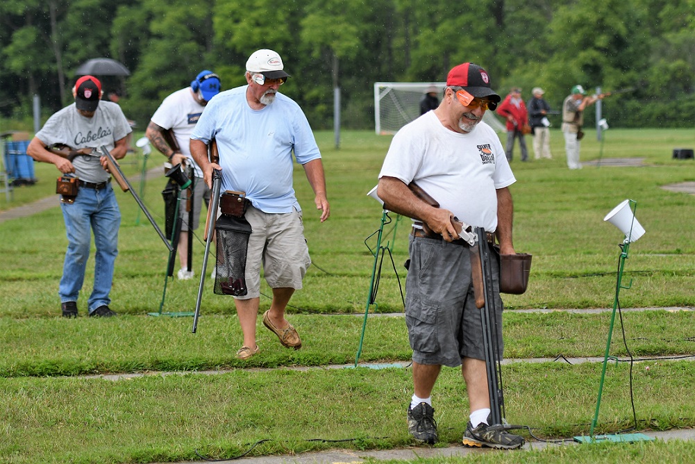 Shooters move to the next station at their trap in the handicap event