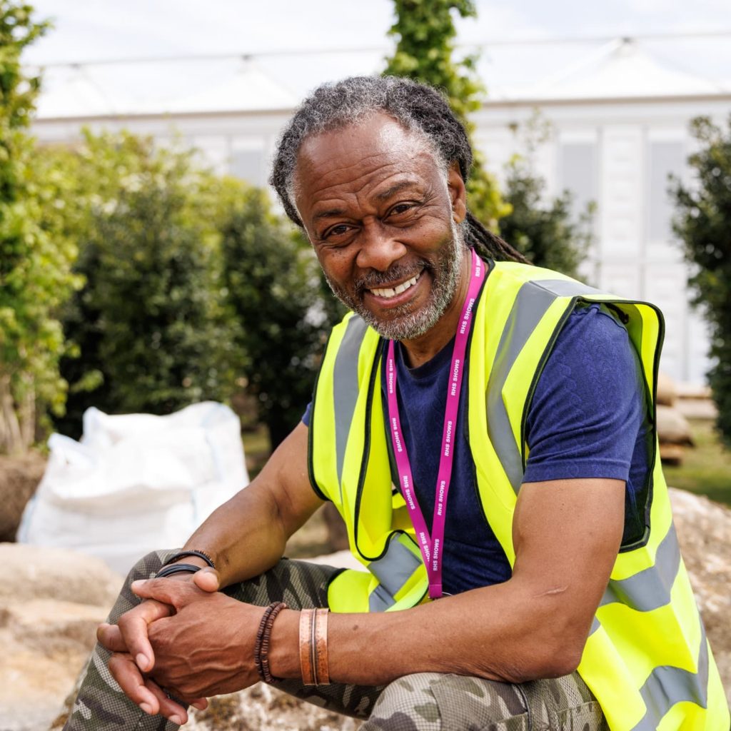 danny clarke with a high visibility jacket on in the garden