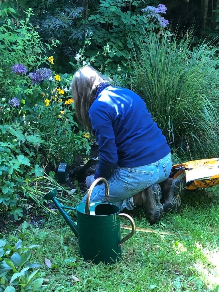 Sally Flatman tending to her garden beds