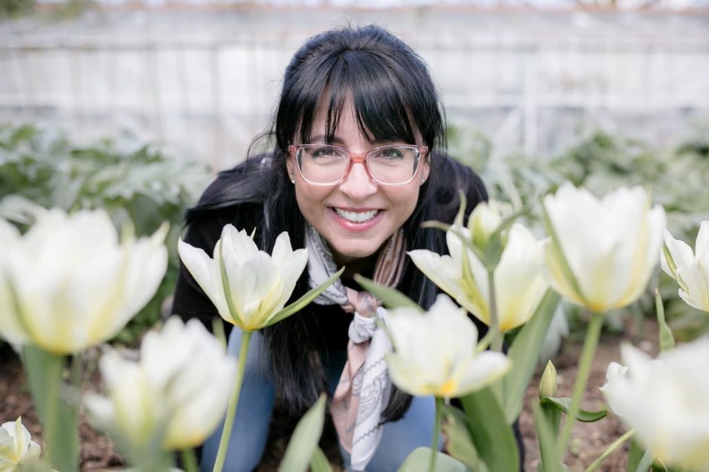 Ellen in the garden with some white flowering tulips
