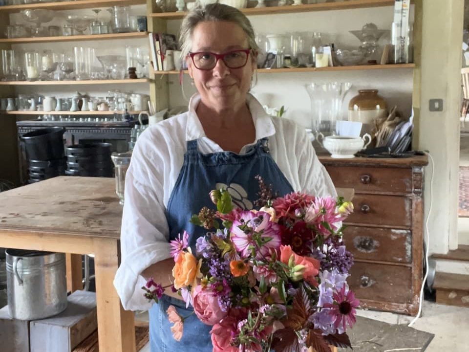 Georgie Newbery holding a bouquet of flowers