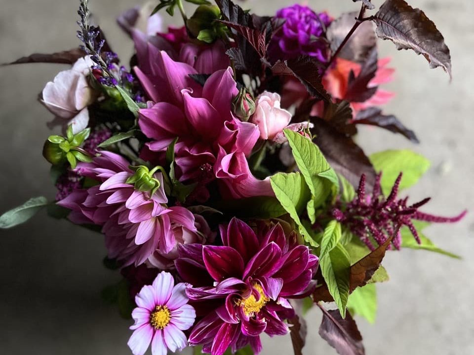 a bouquet arranged by Georgie Newbery featuring various shades of pink flowers
