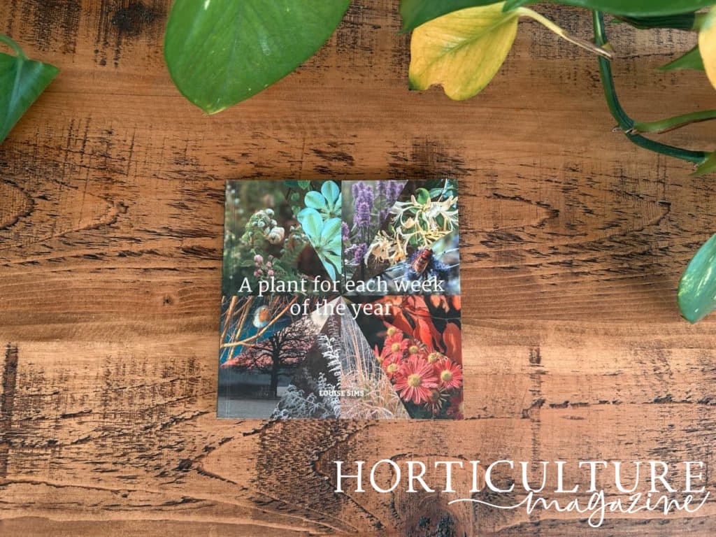 Louise Sims' book ‘a plant for each week of the year’ on a wooden table
