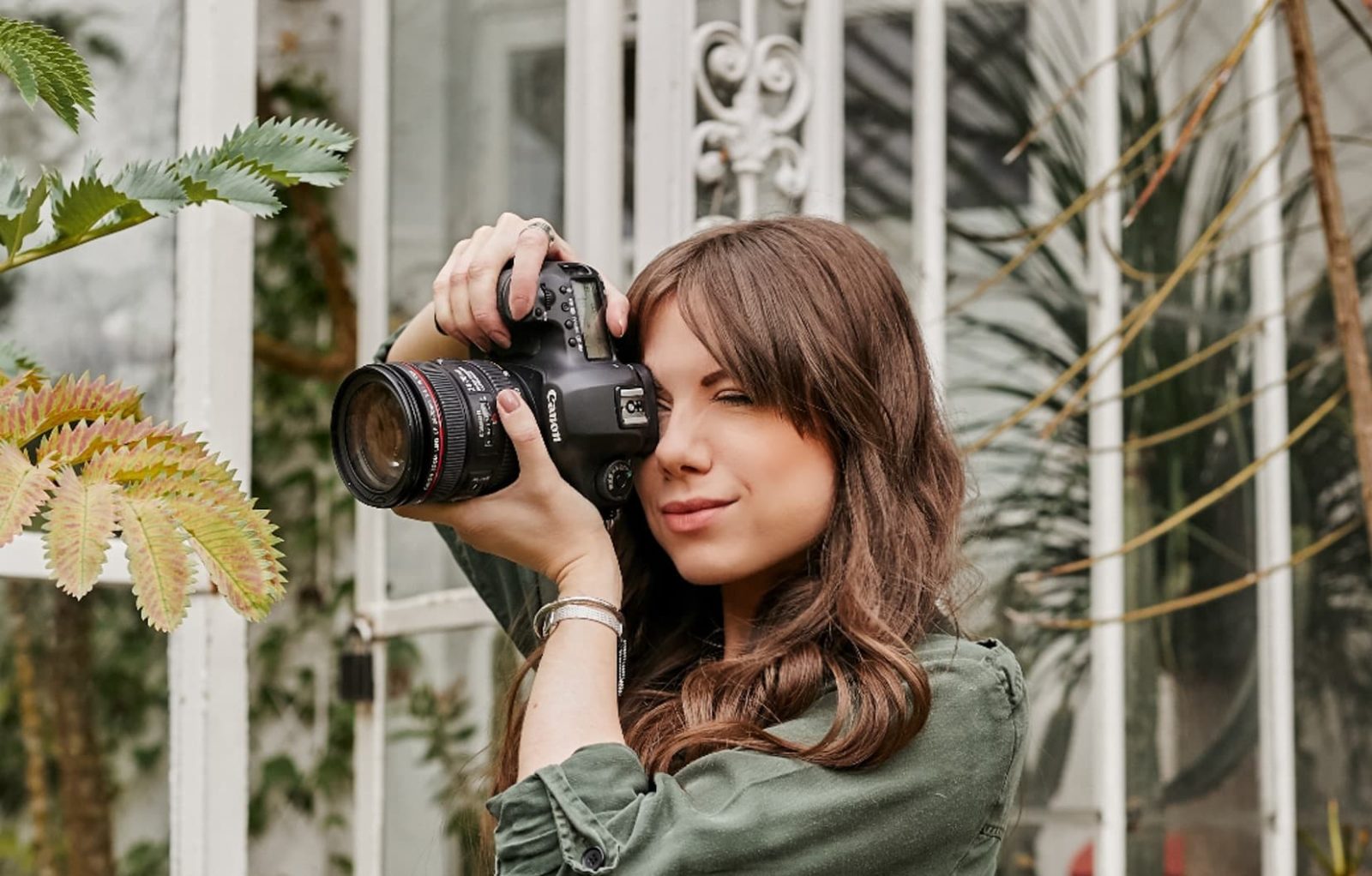 Marina Walker taking a photograph outdoors of a garden