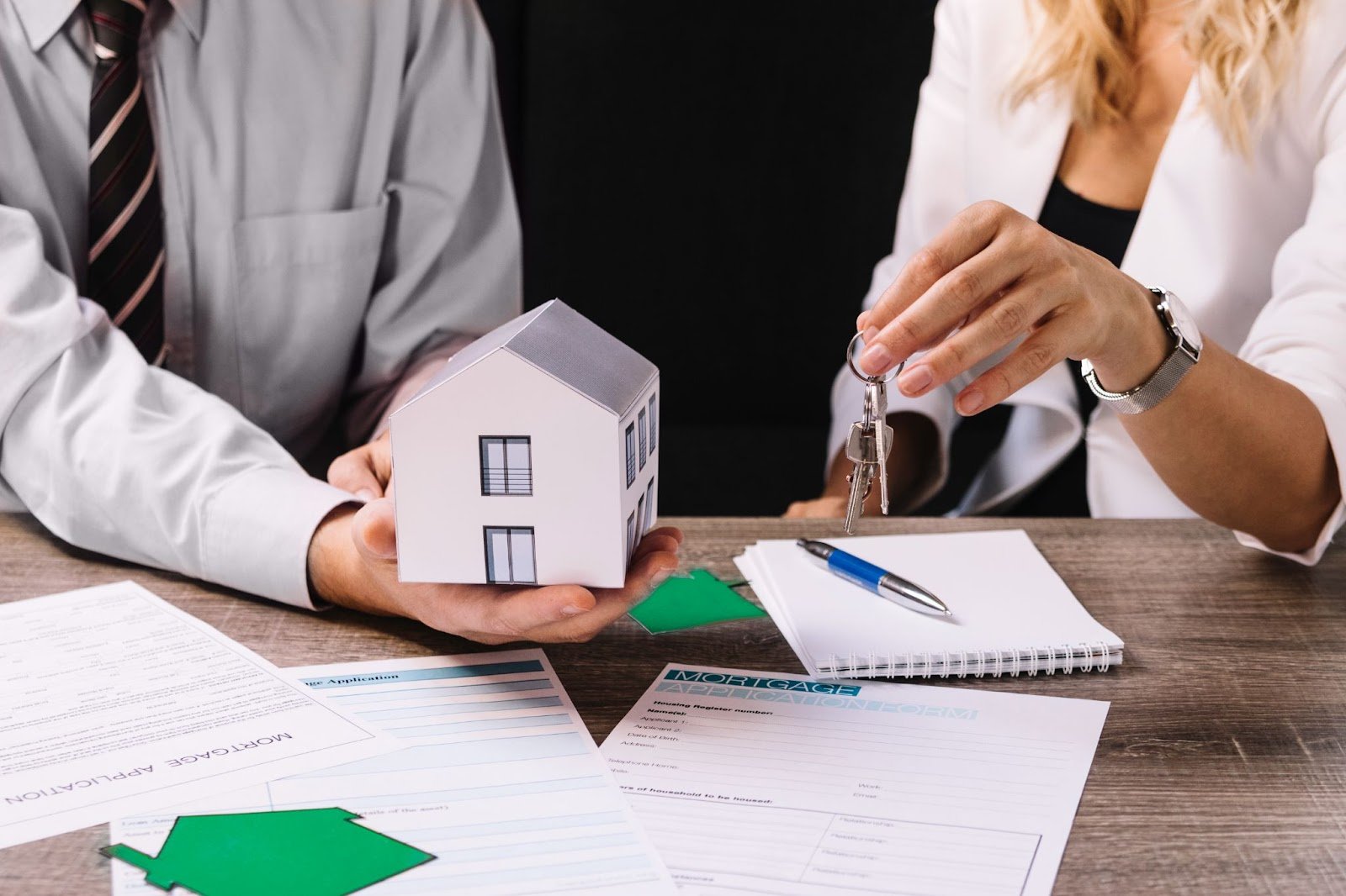 IMAGE OF A PERSON HOLDING MODEL HOME