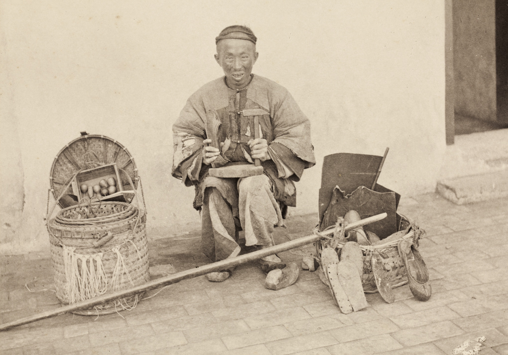A shoe mender with tools and travelling pack Historical Photographs of China