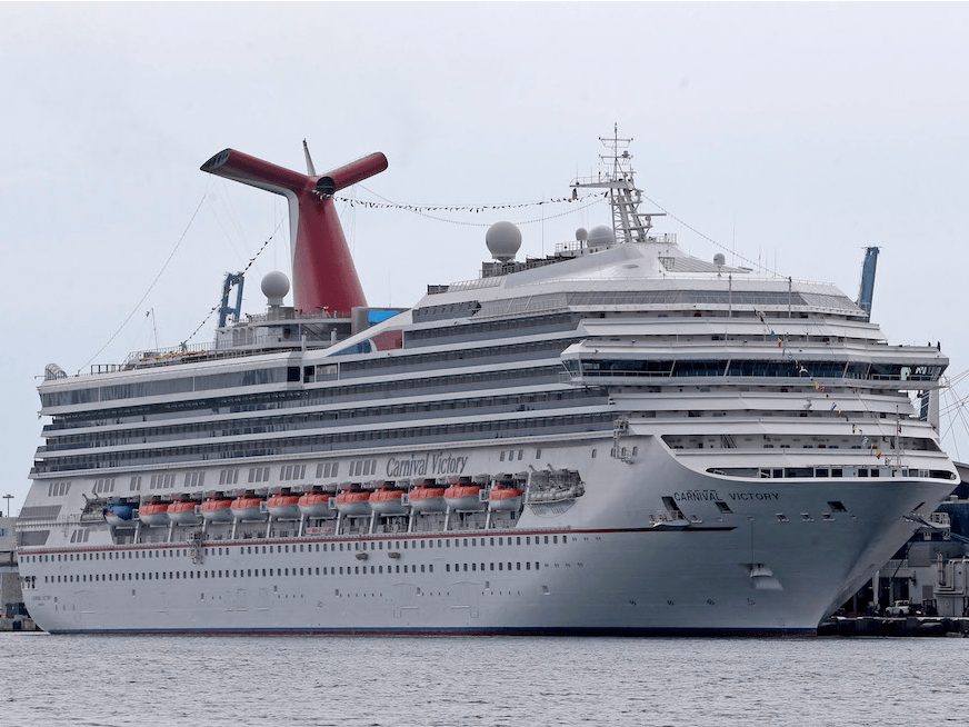 A Carnival Cruise Ship Tilted Sideways With Passengers Onboard