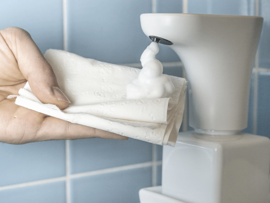 This touchfree dispenser turns regular toilet paper into wet wipes
