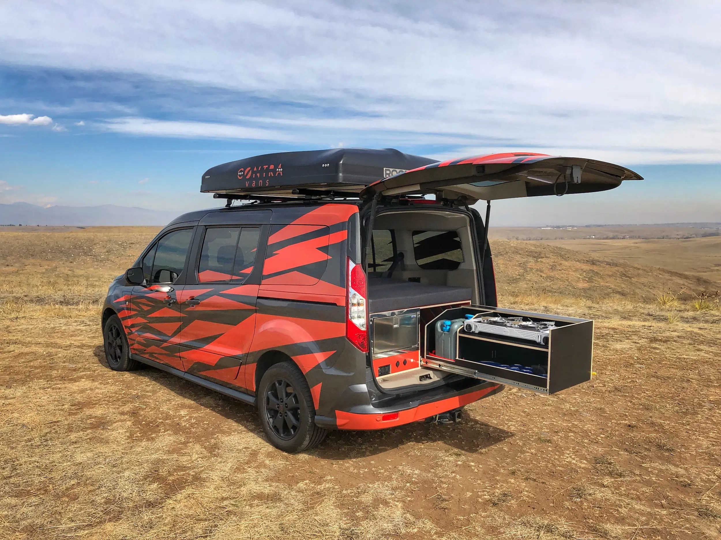This tiny, 15,000 camper van conversion sleeps 5 people and fits in