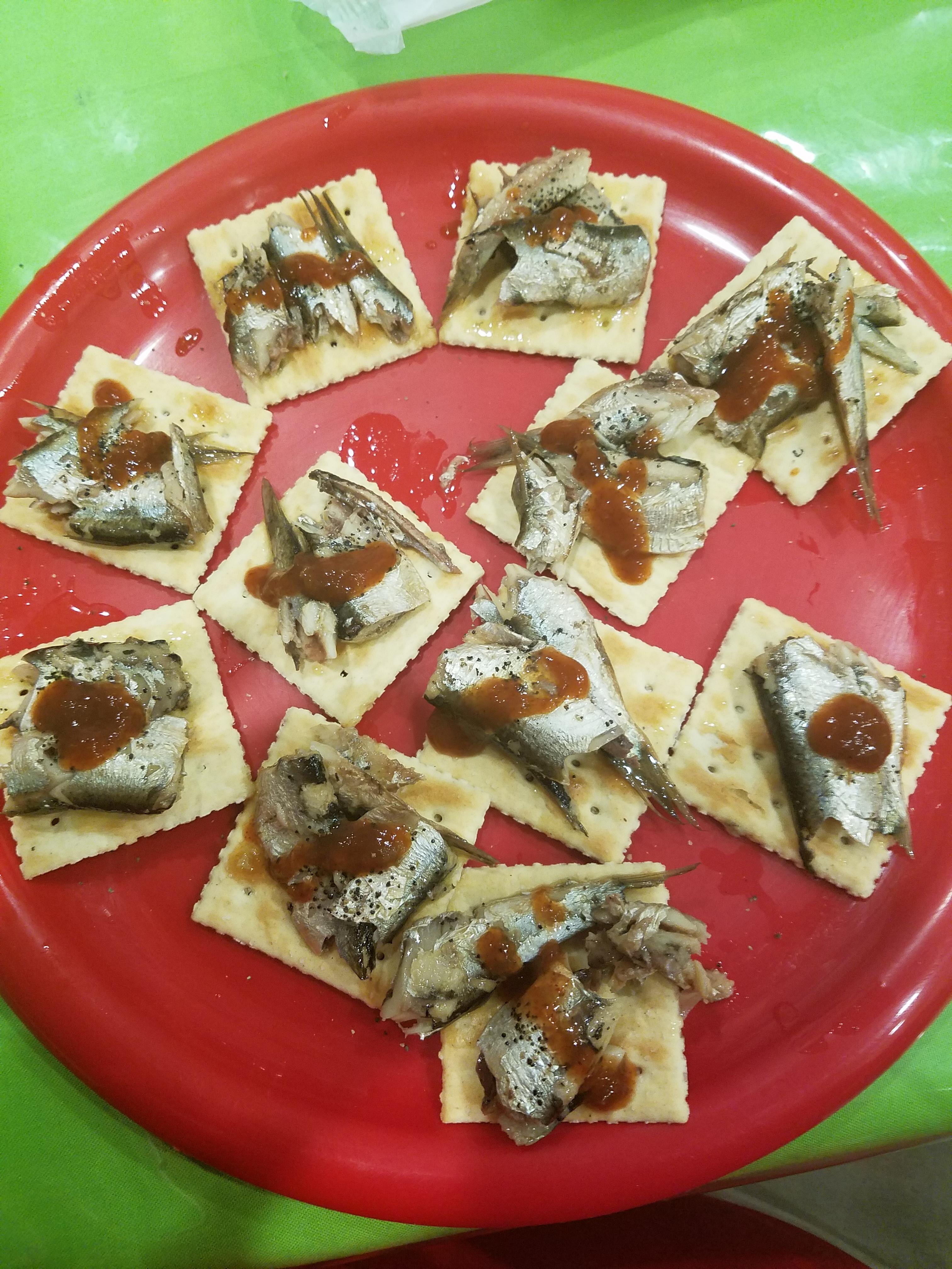 Dinner tonight Sardines on saltines with pepper and taco bell fire