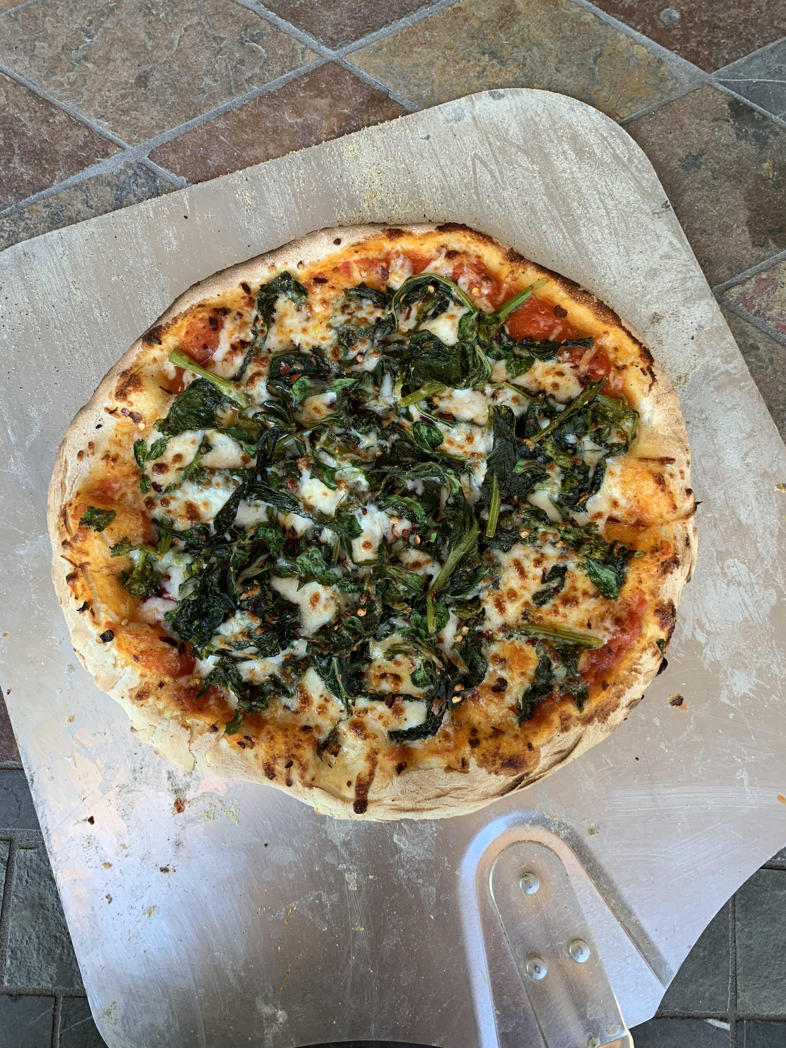 Rapini pizza with buffalo mozzarella, San Marzano tomatoes, and crushed