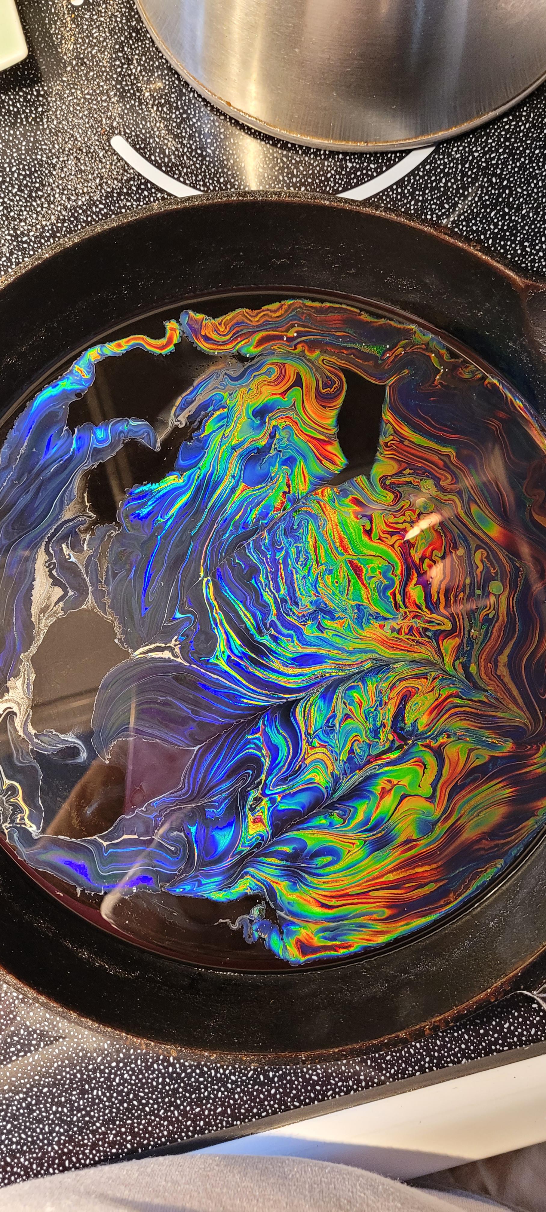 Sunflower oil, splash of olive oil in cast iron pan. Oil Rainbow. r