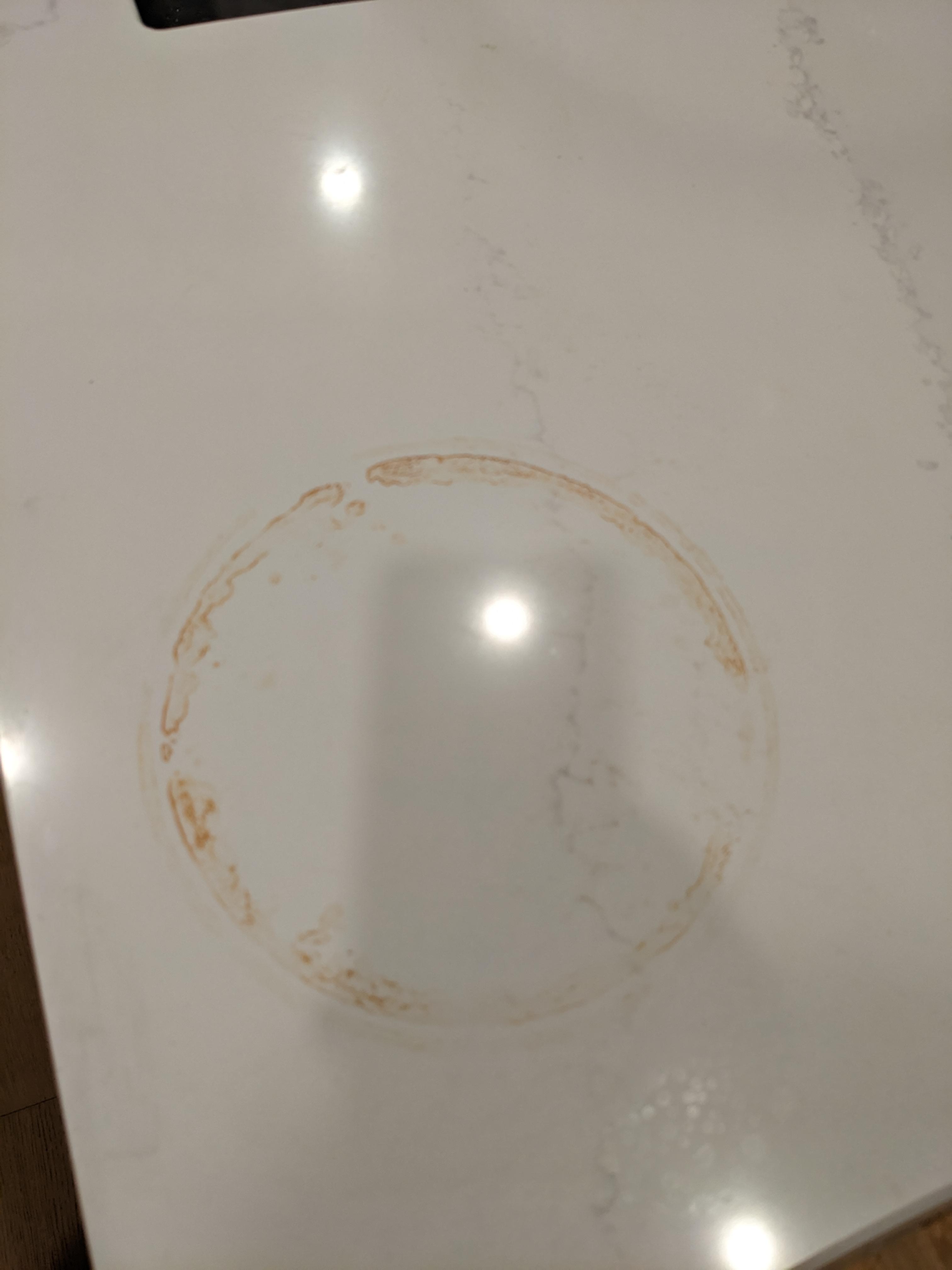 How to remove rust stain from white kitchen countertop caused by a