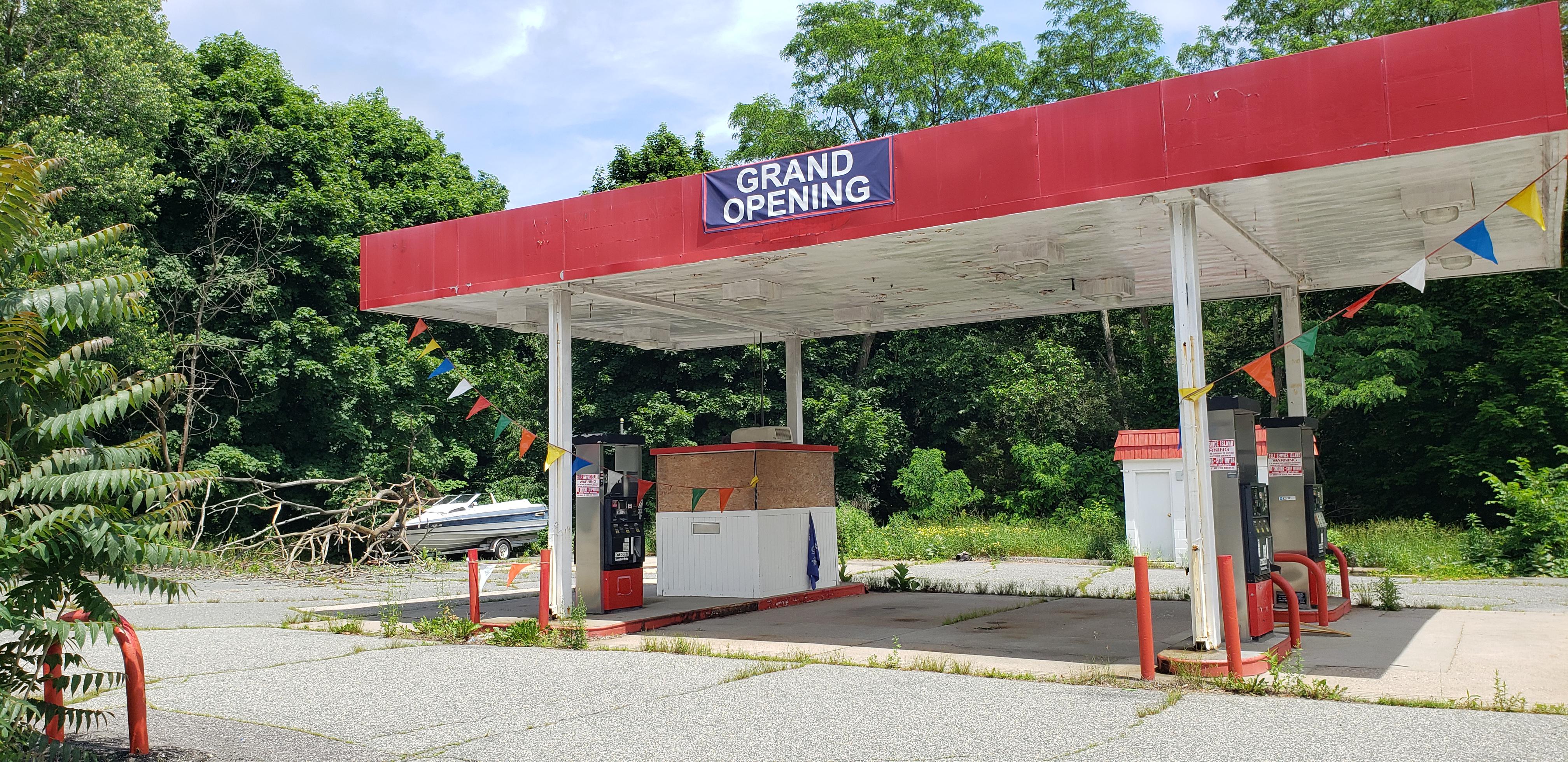 This abandoned gas station with the Grand Opening sign still up r