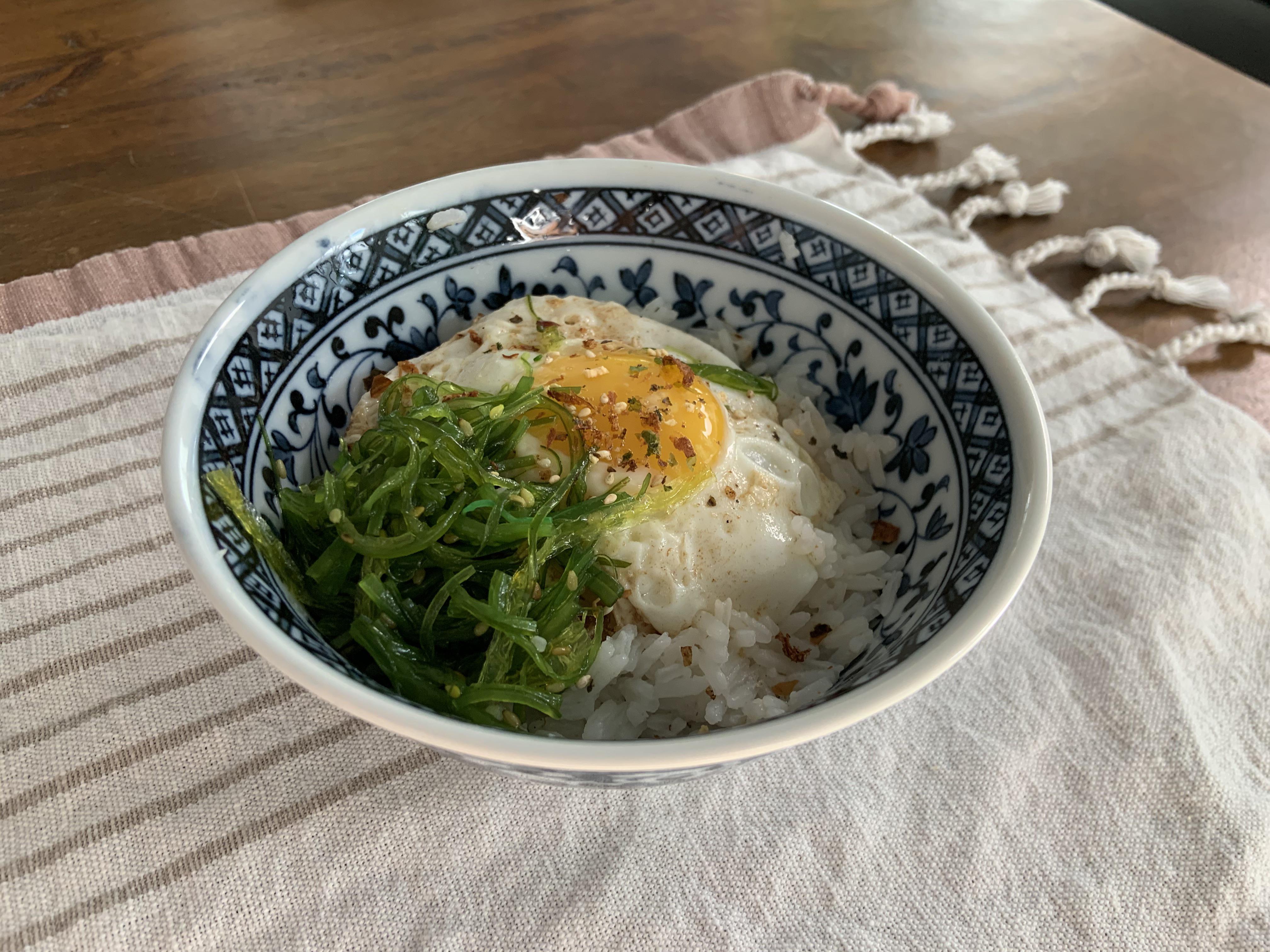 Fried egg on rice with seaweed salad and furikake is a delicious, easy