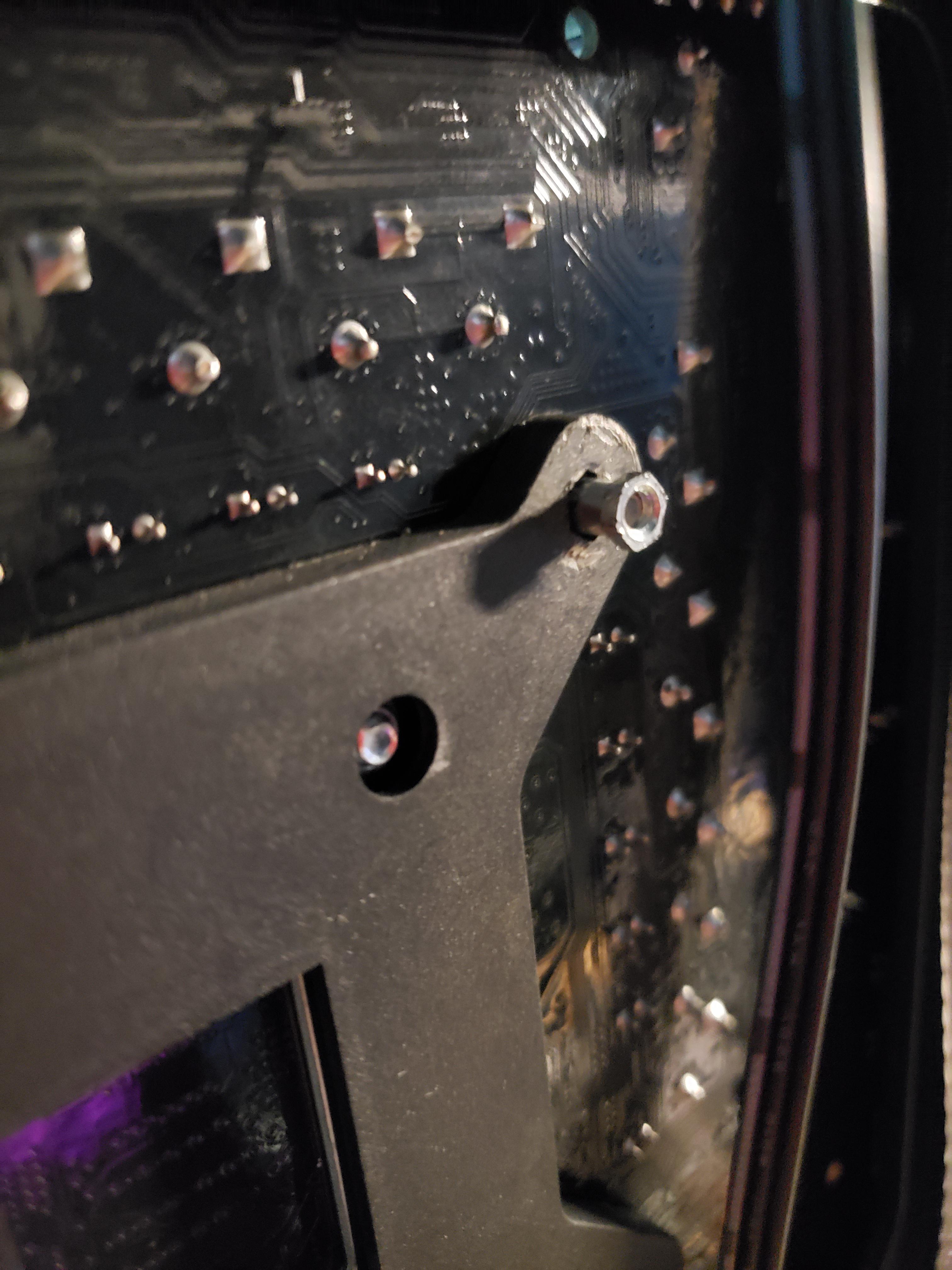 Standoff became stuck to motherboard. How do I take it off if the screw