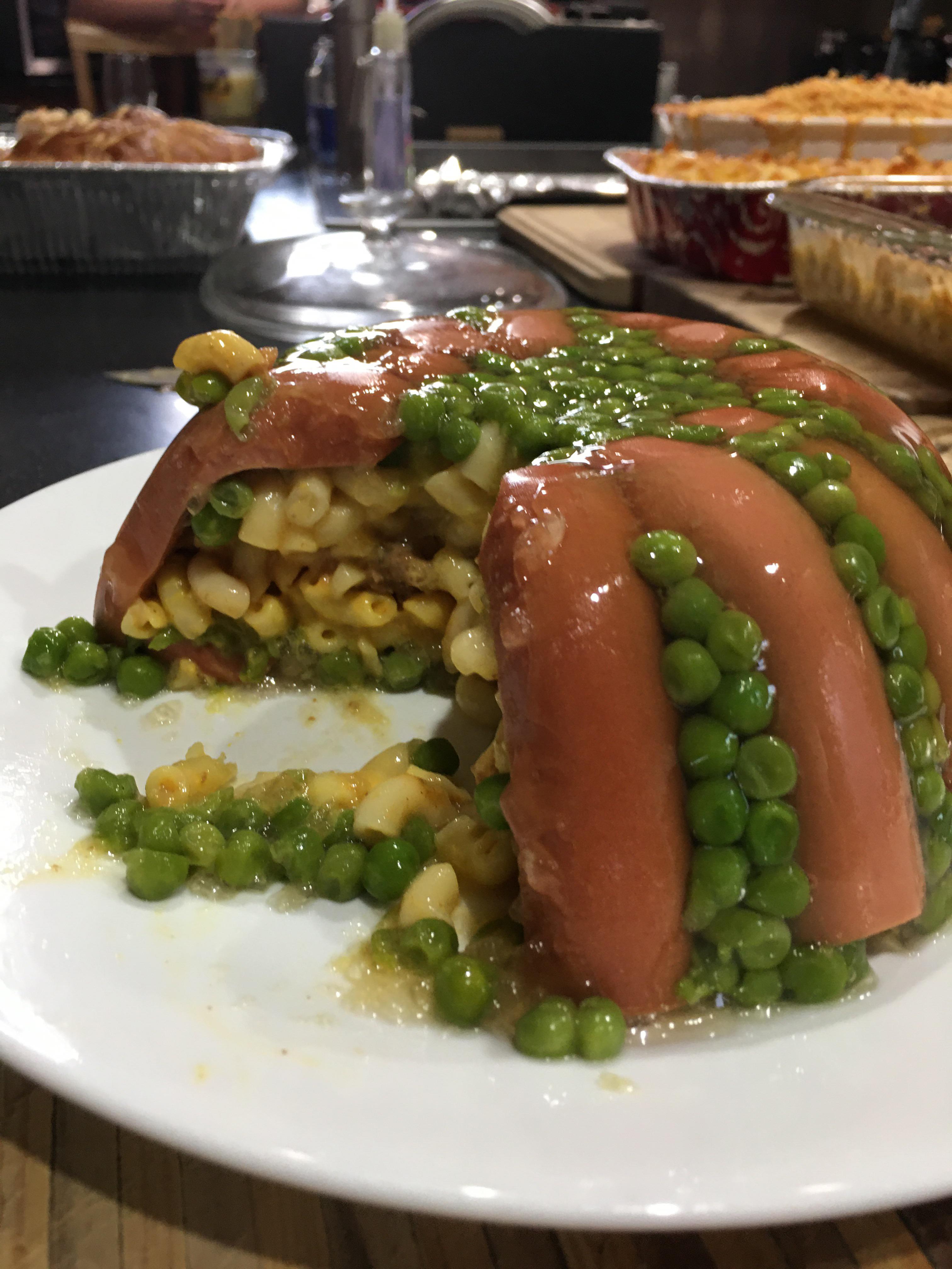 Mac n cheese in beef jello with hotdogs, peas, and chili Mac in the