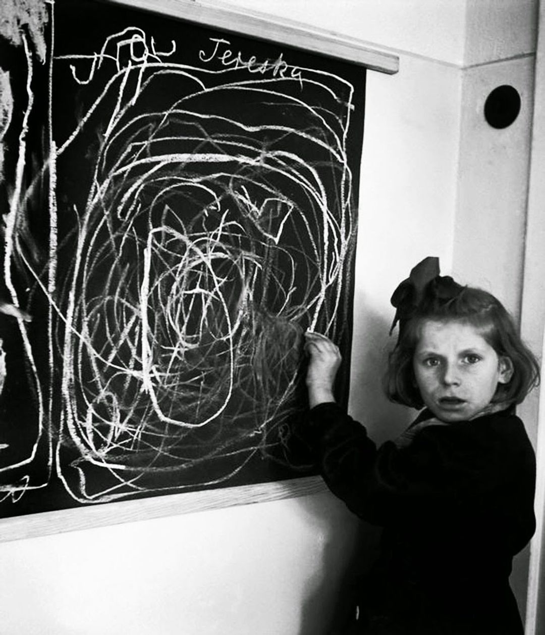 A girl who grew up in a war zone draws a picture of "home" while living