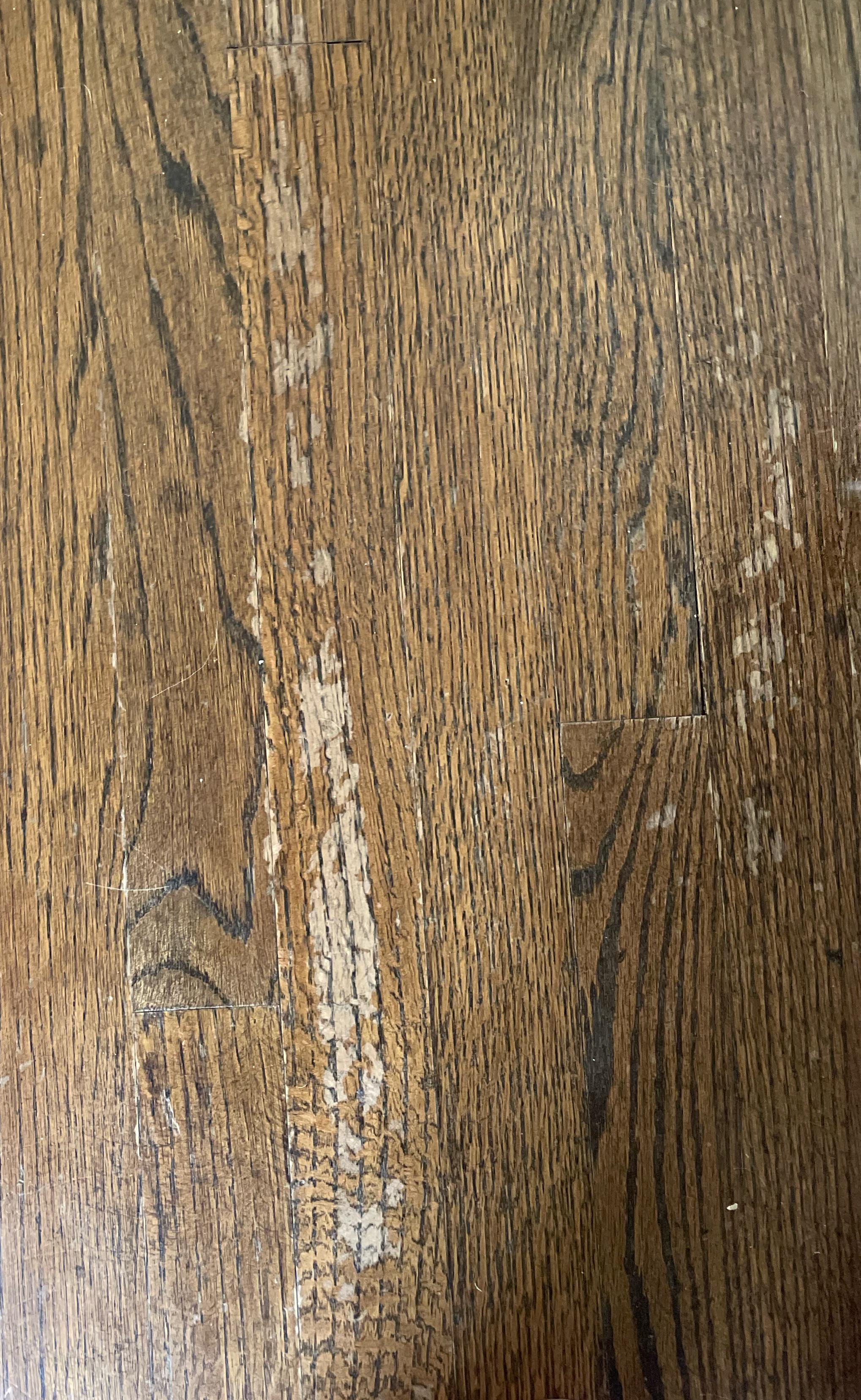 What causes finish on a floor to come up like this (bought a house and