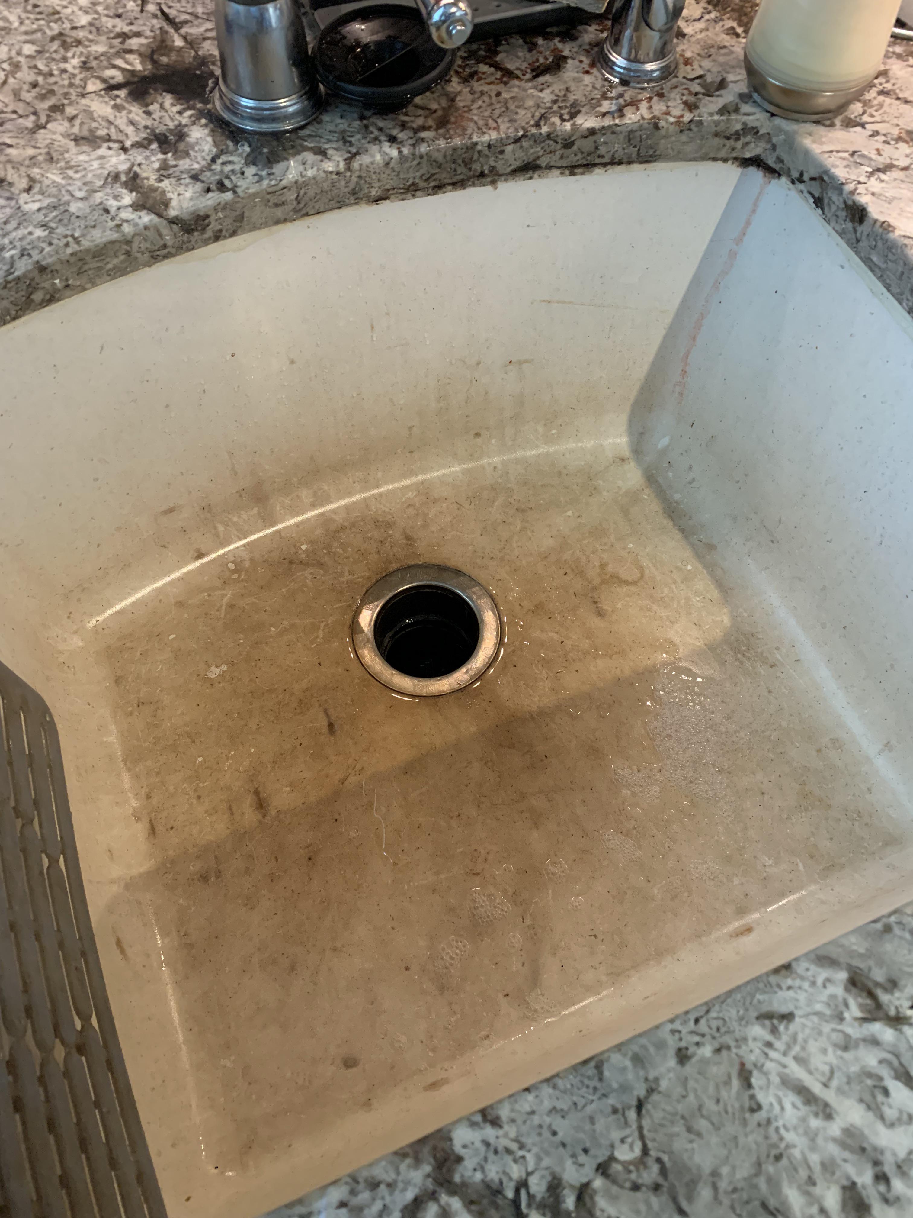 Tips on how to clean this sink? Porous material, not sure what it is