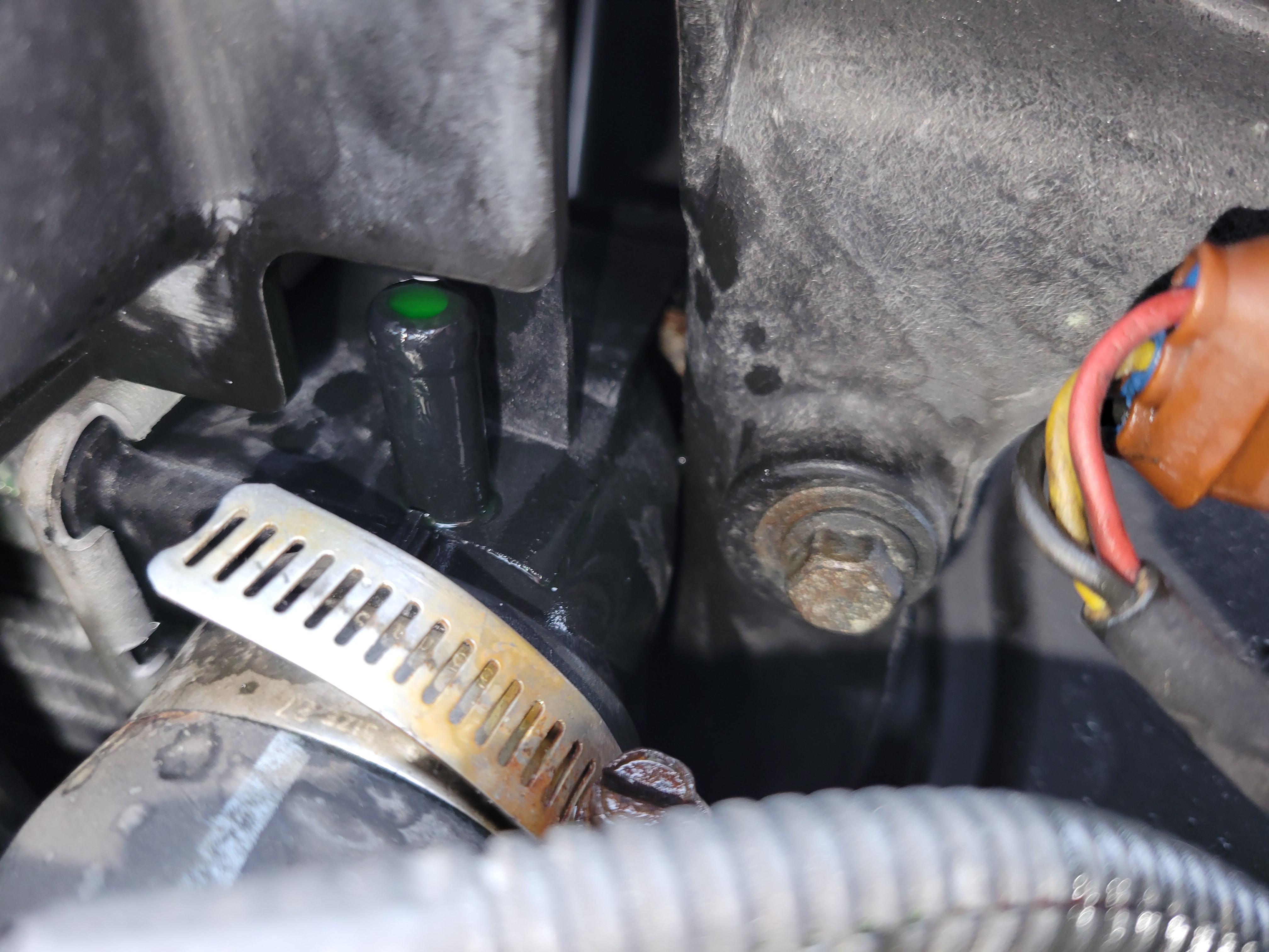 Why is my coolant leaking out of this part of my car, even when I add only a little coolant? r