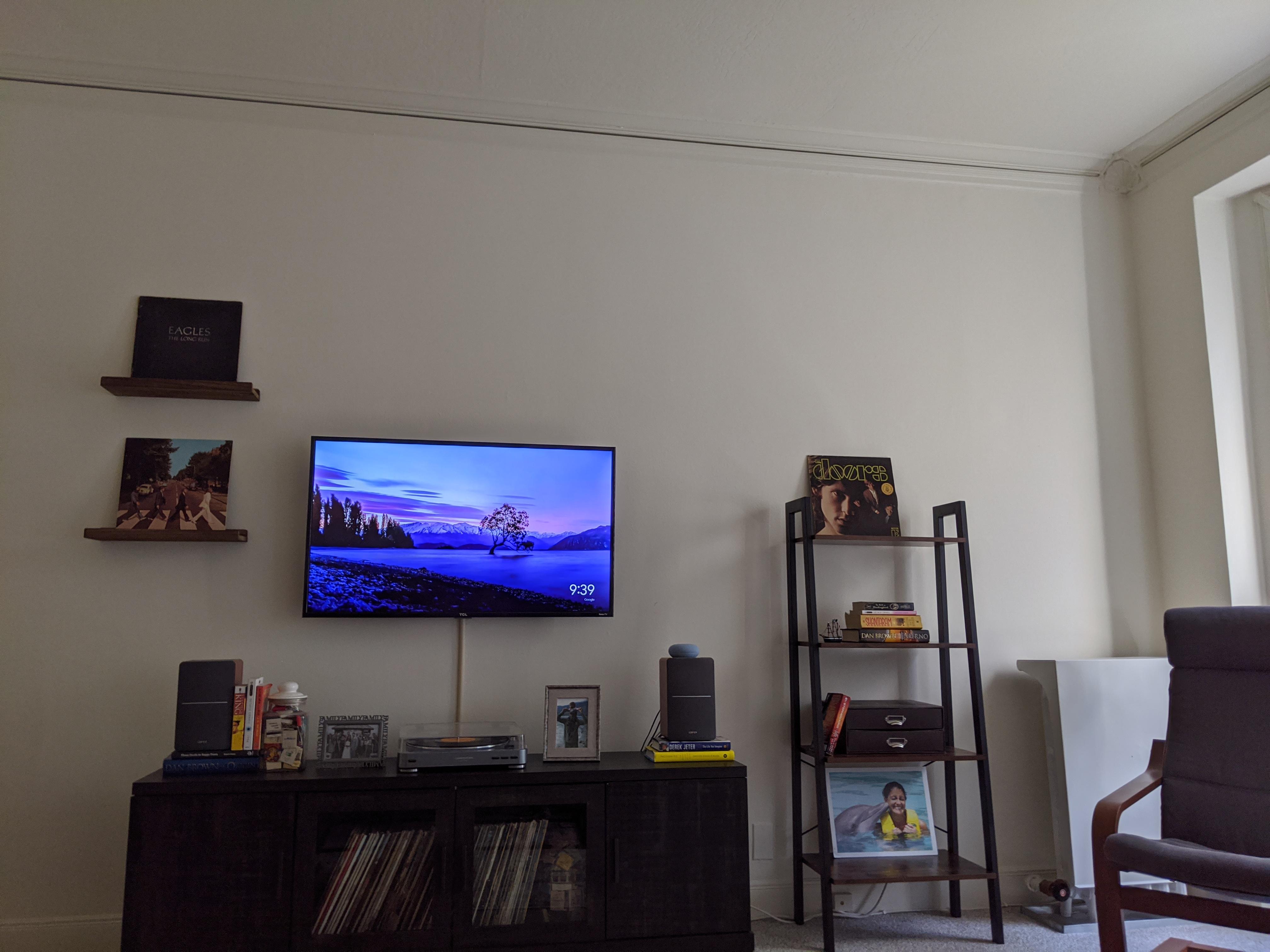 Need help filling the wall space above my TV and book shelf. Any ideas for art, etc? r