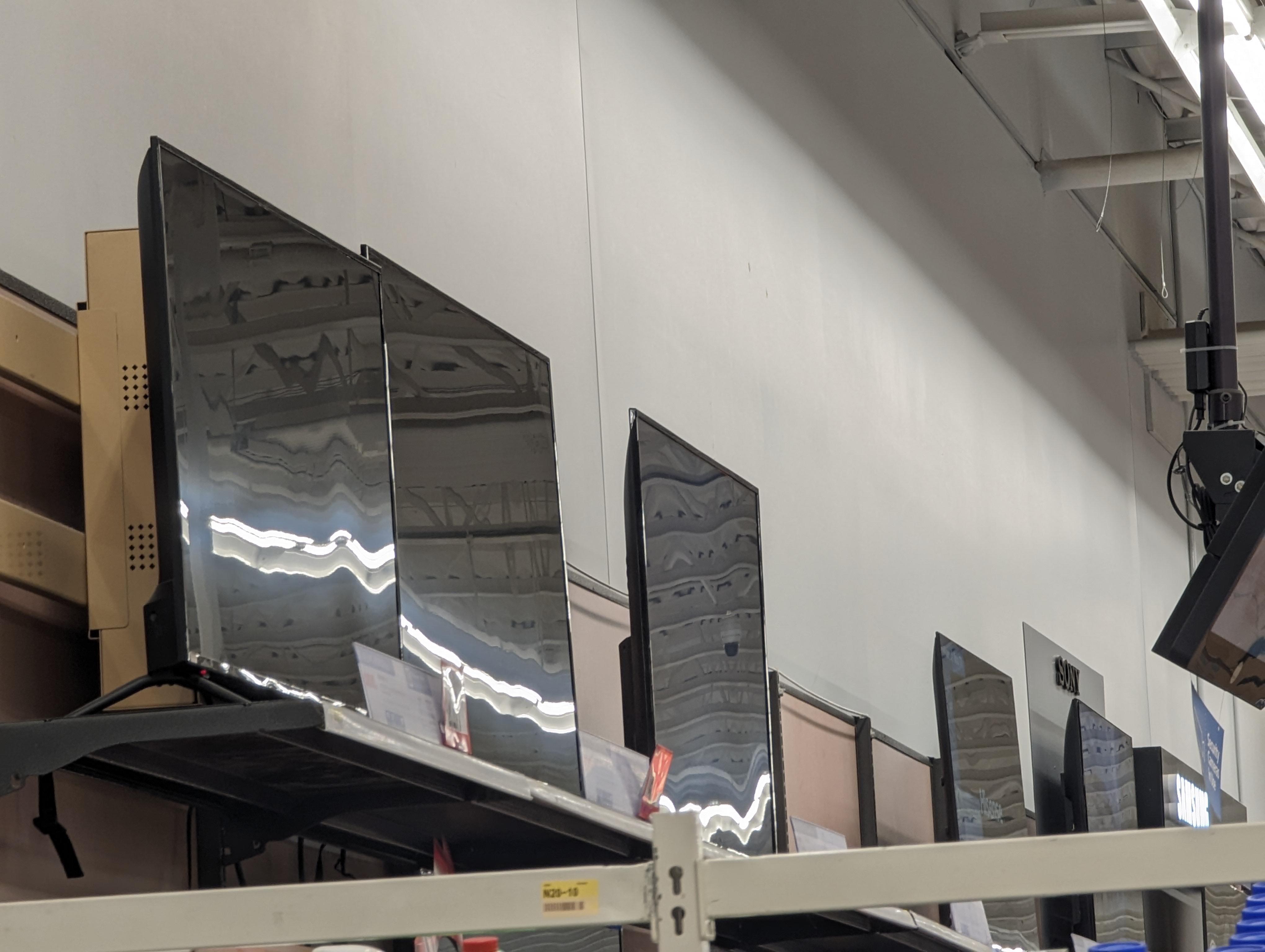 If these were Plasma TVs, the flourescent light reflections would be in