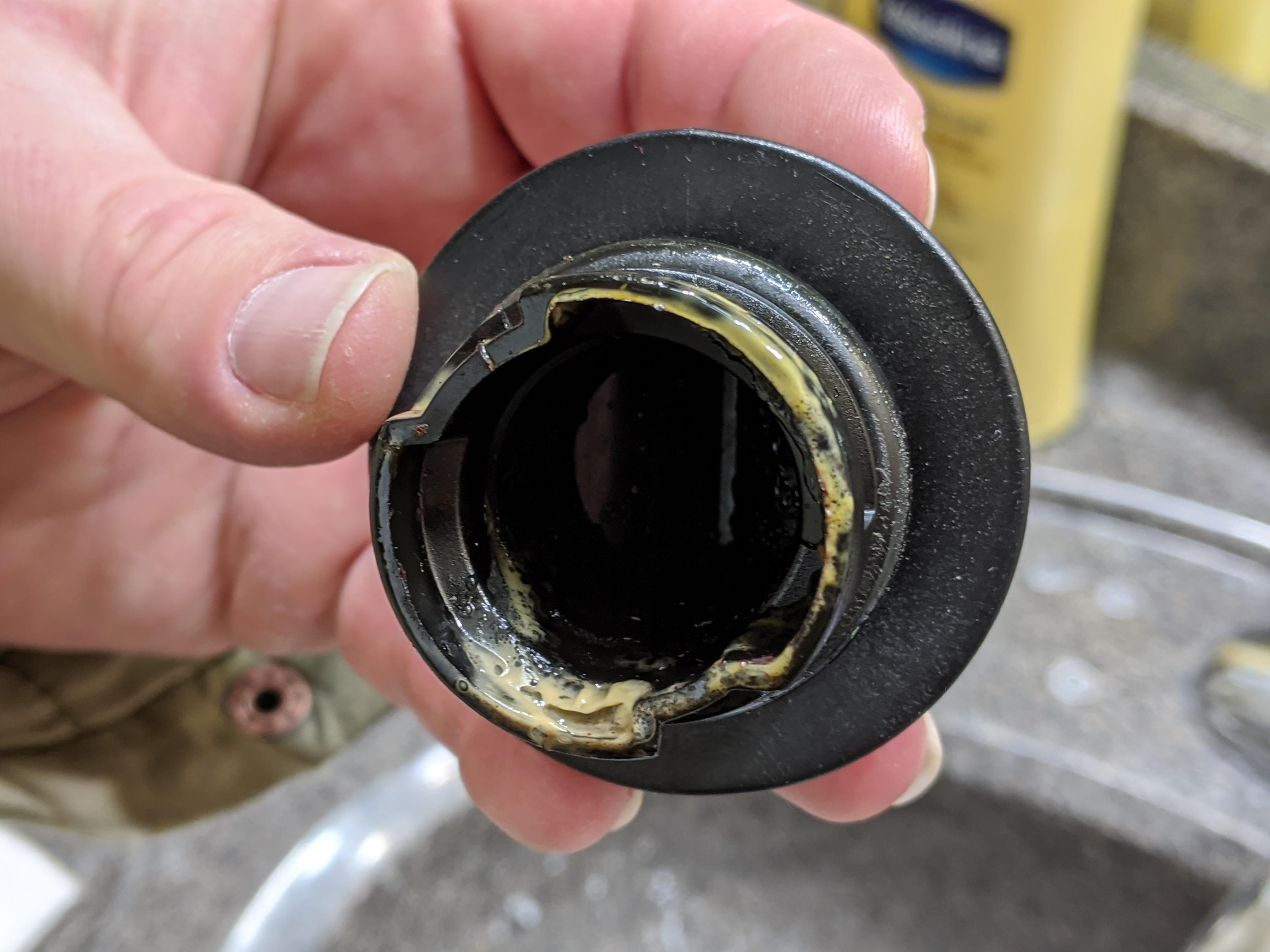 What could this yellow gunk be? Found on inside of oil cap of 2018