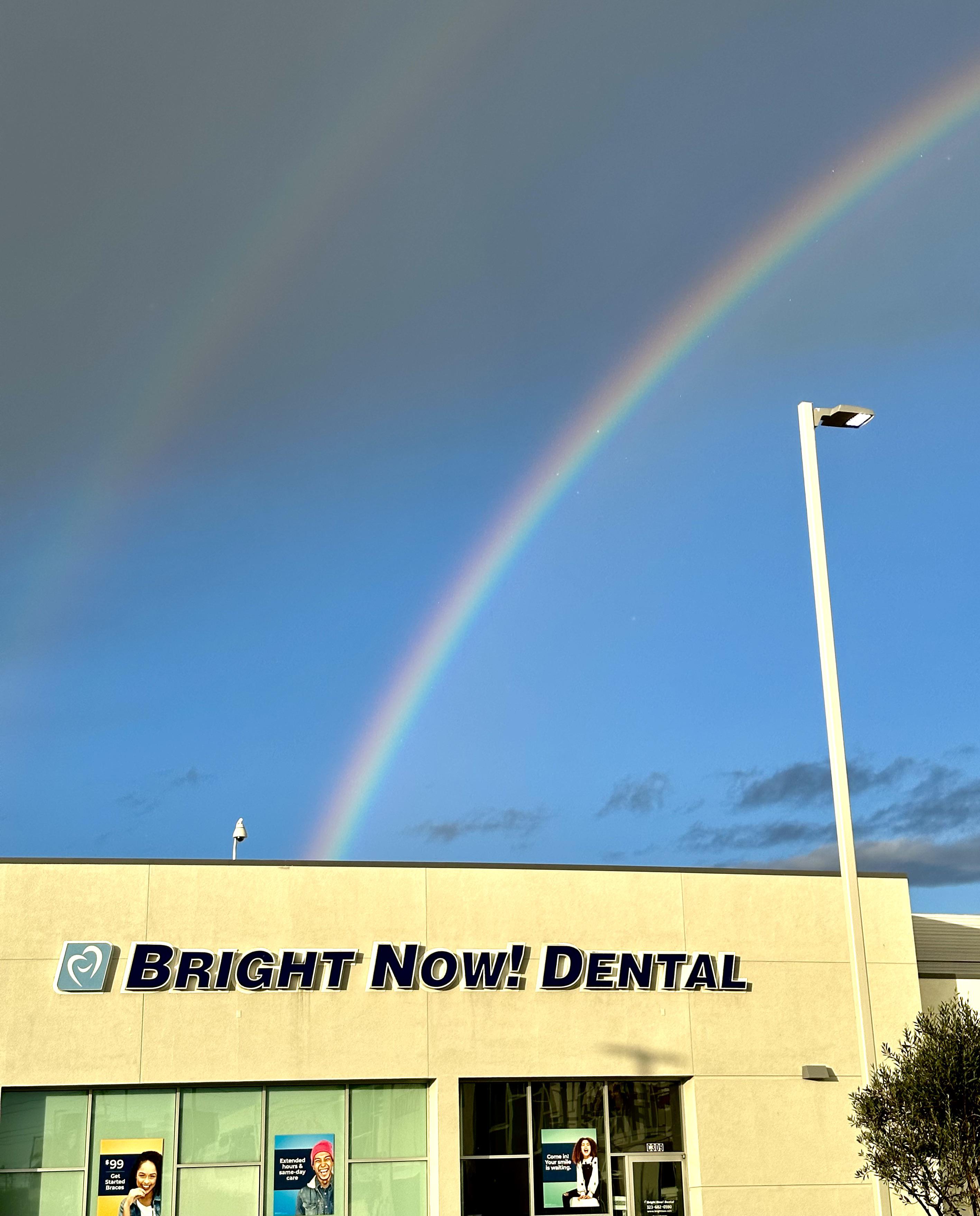 Rainbow ends perfectly at “Bright Now! Dental” sign r/mildlyinteresting