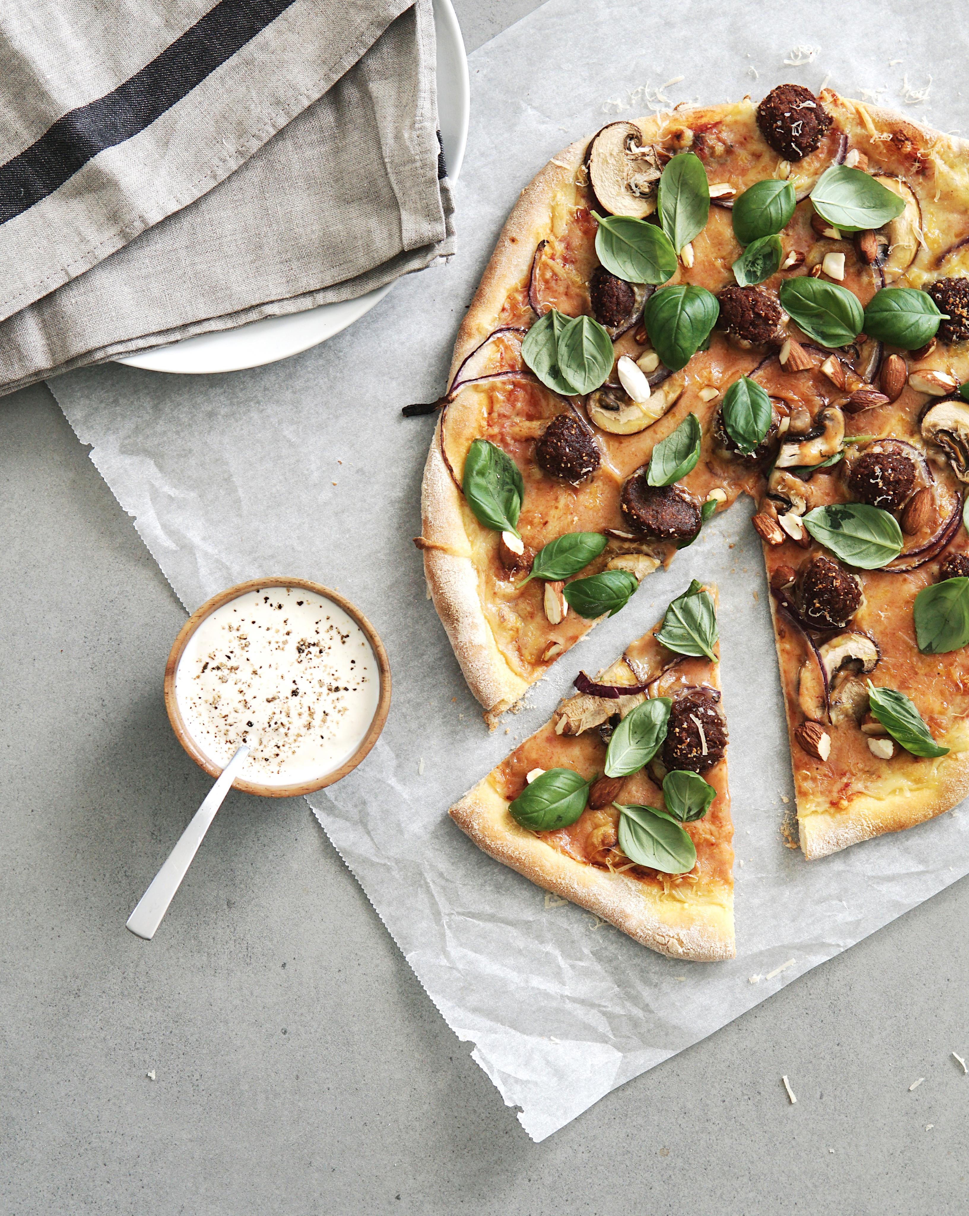 Vegan pizza with mushrooms, soy meatballs, red onions, toasted almonds and basil. r/Pizza