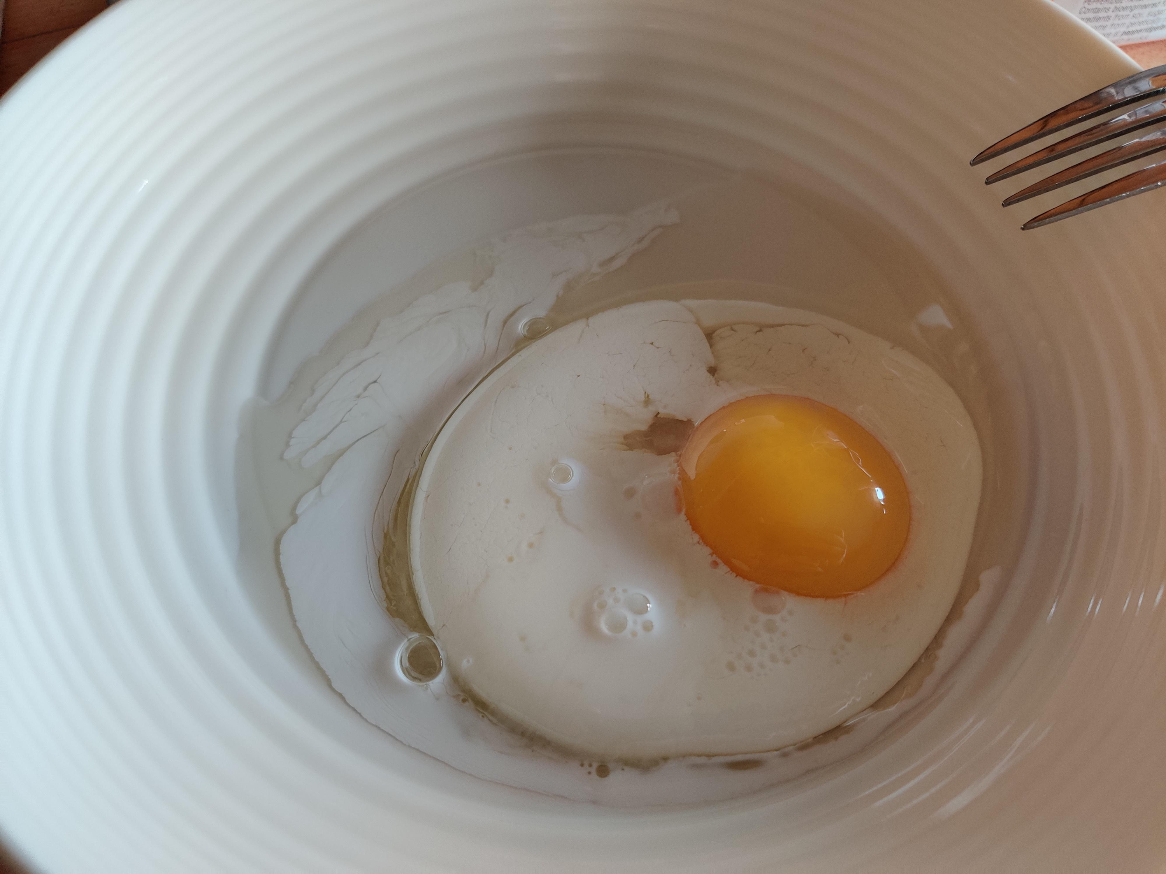 This raw egg looked cooked after I poured milk into the bowl r