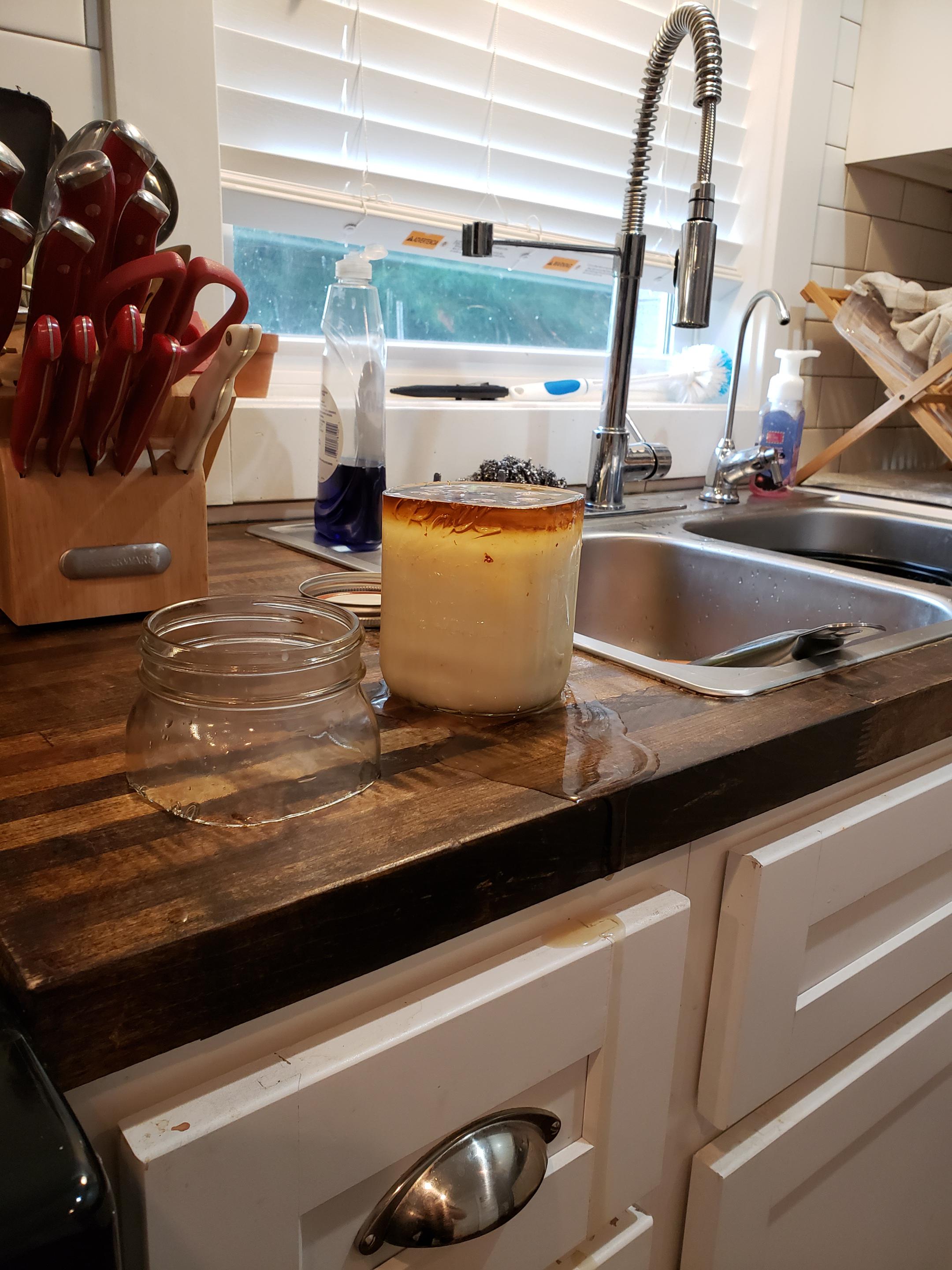 Hot bacon grease created a clean cut across this mason jar. r