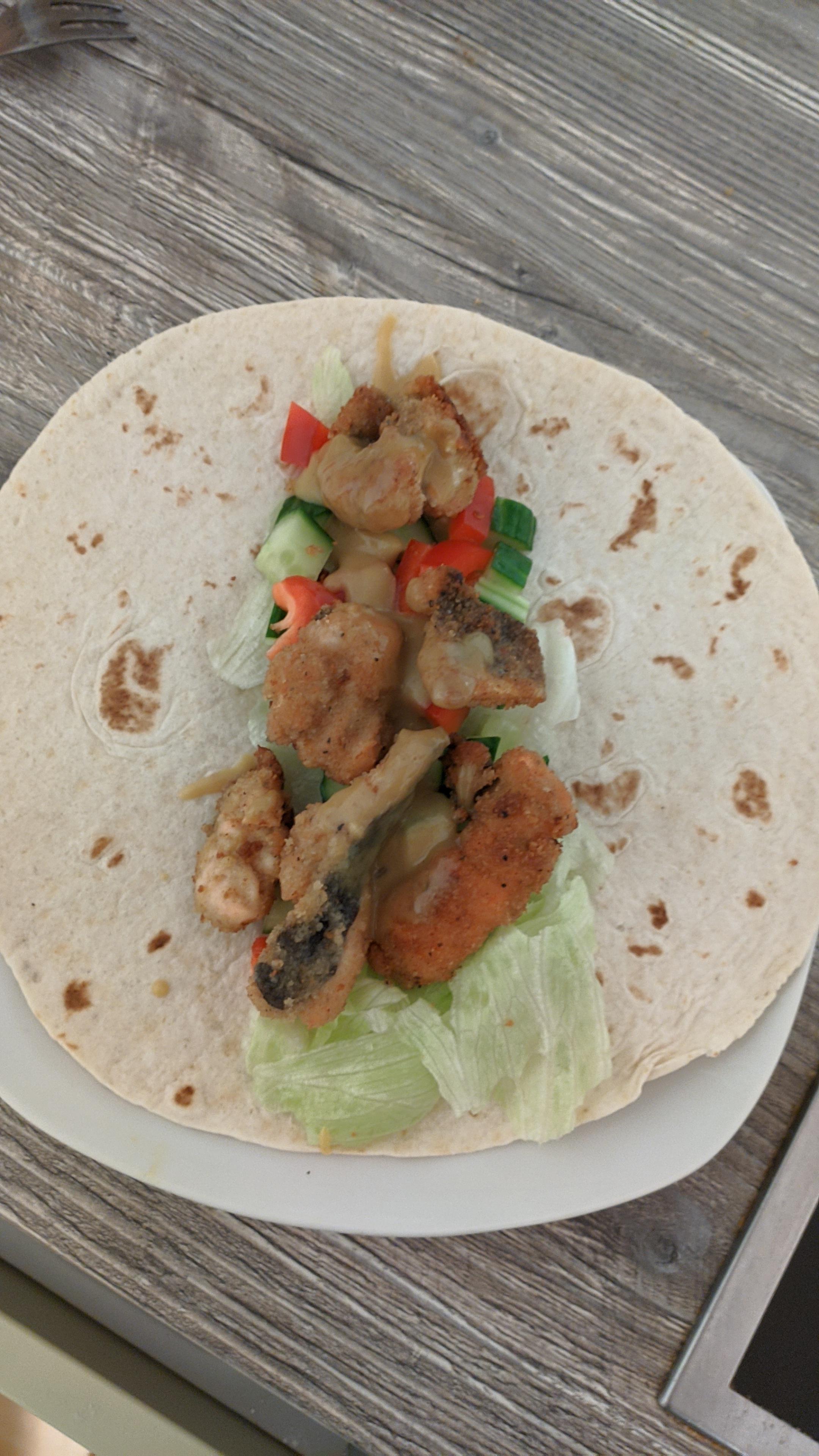 Delicious trout wrap with honeymustardsauce and fresh vegetables. r