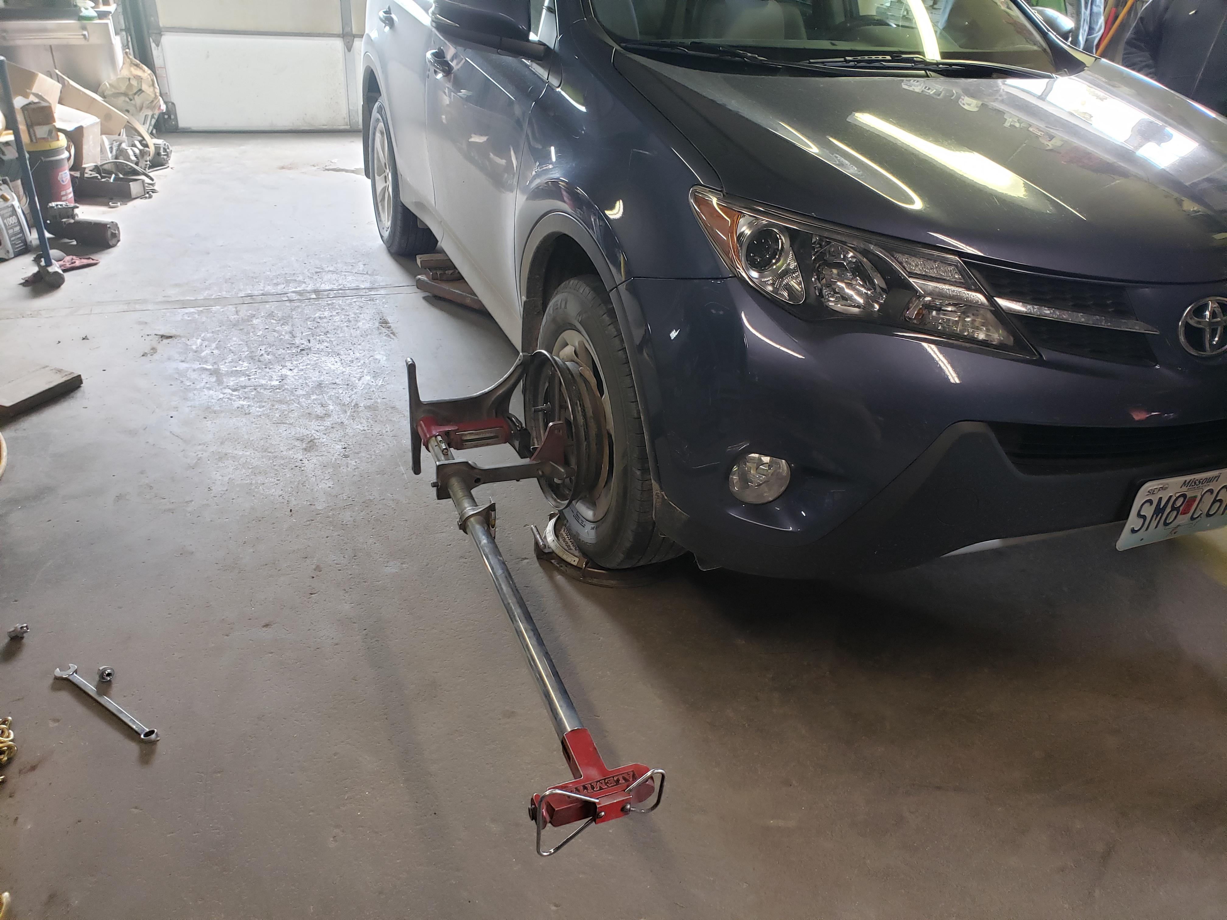 Old school alignment setup, dang new rims don't have a lip for our