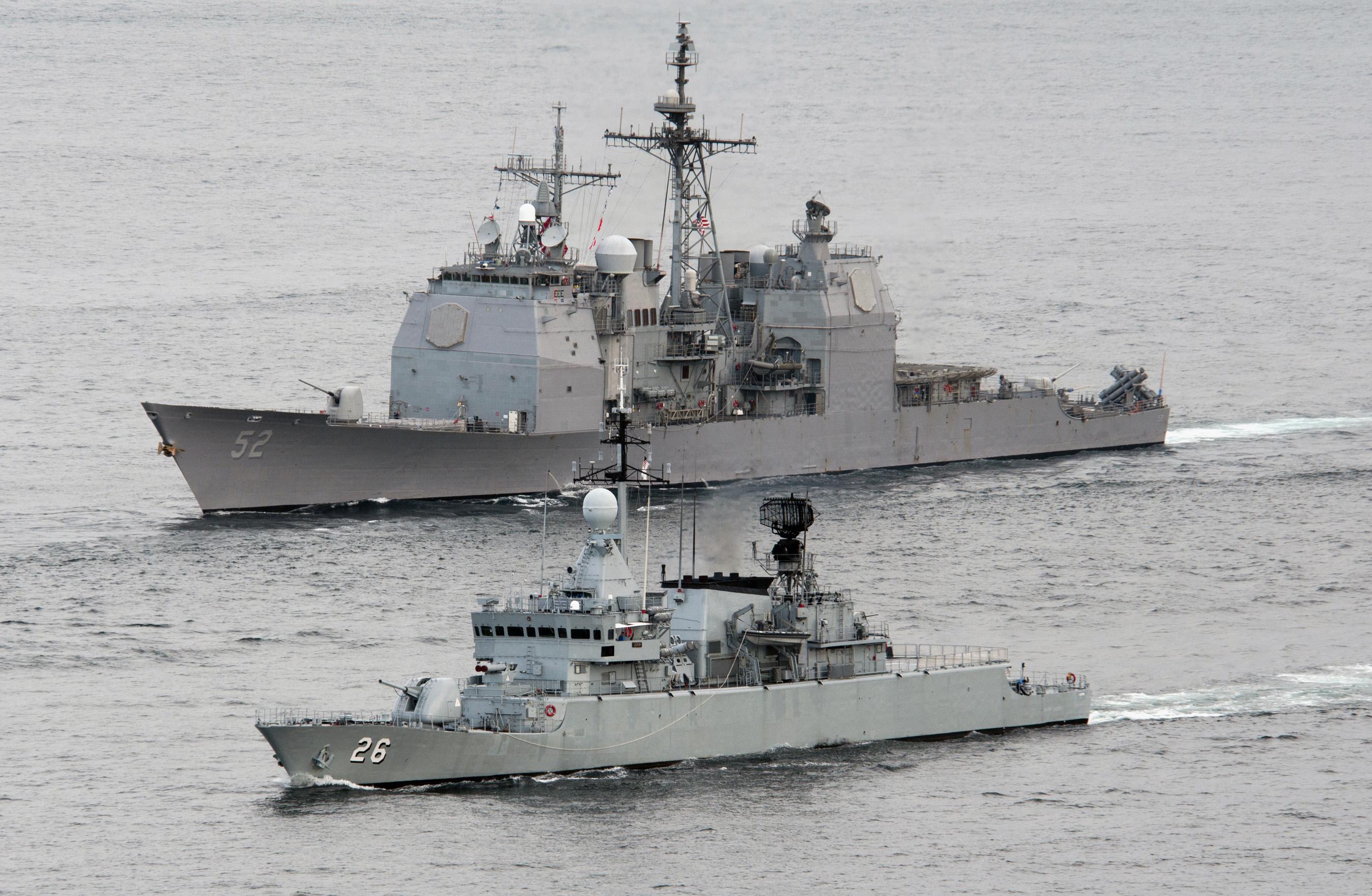 The Royal Malaysian Navy frigate KD Lekir (FF 26) leads the Ticonderoga