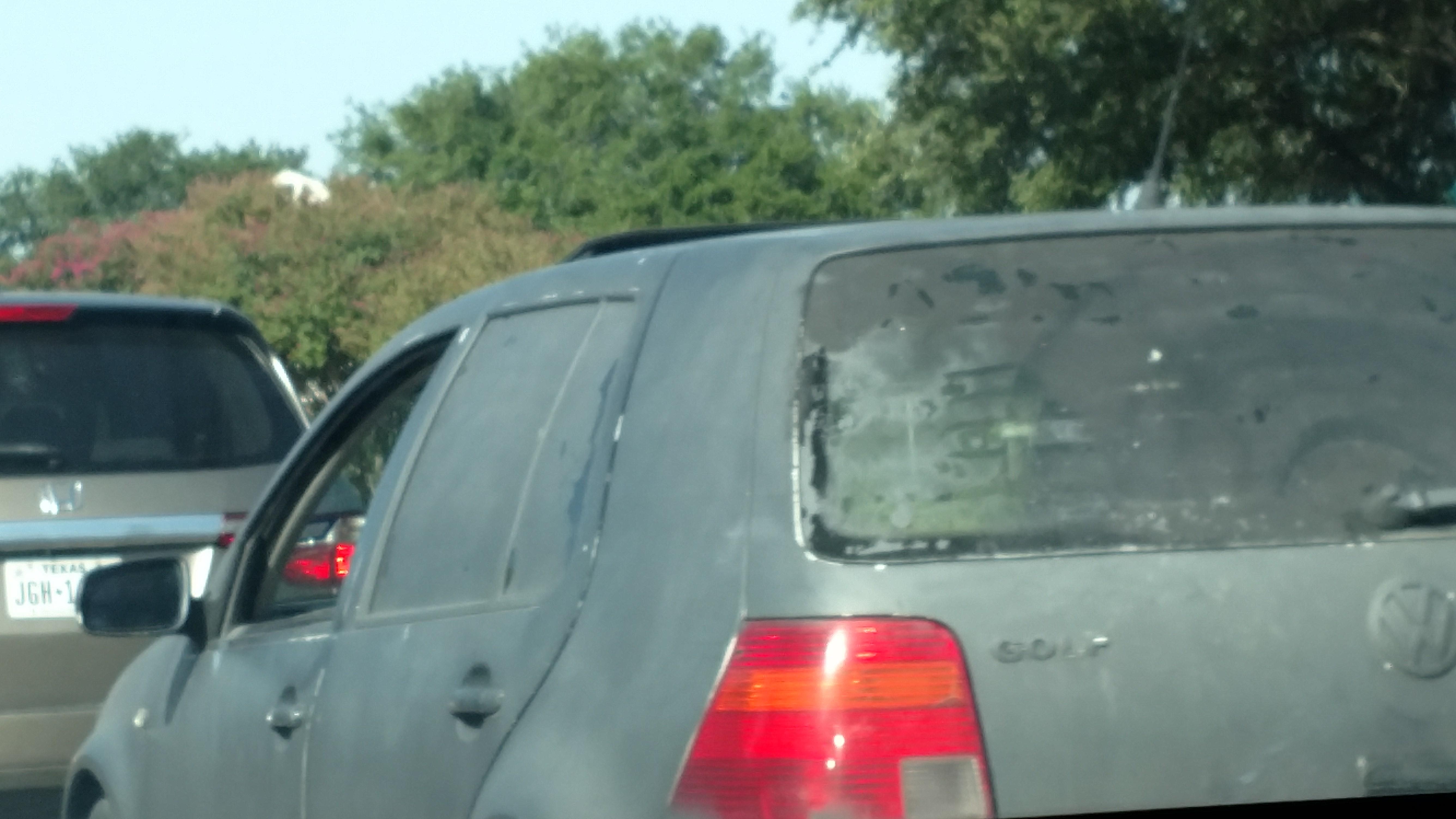 VW Golf. Entire car spray painted black. Painted over rear windows and