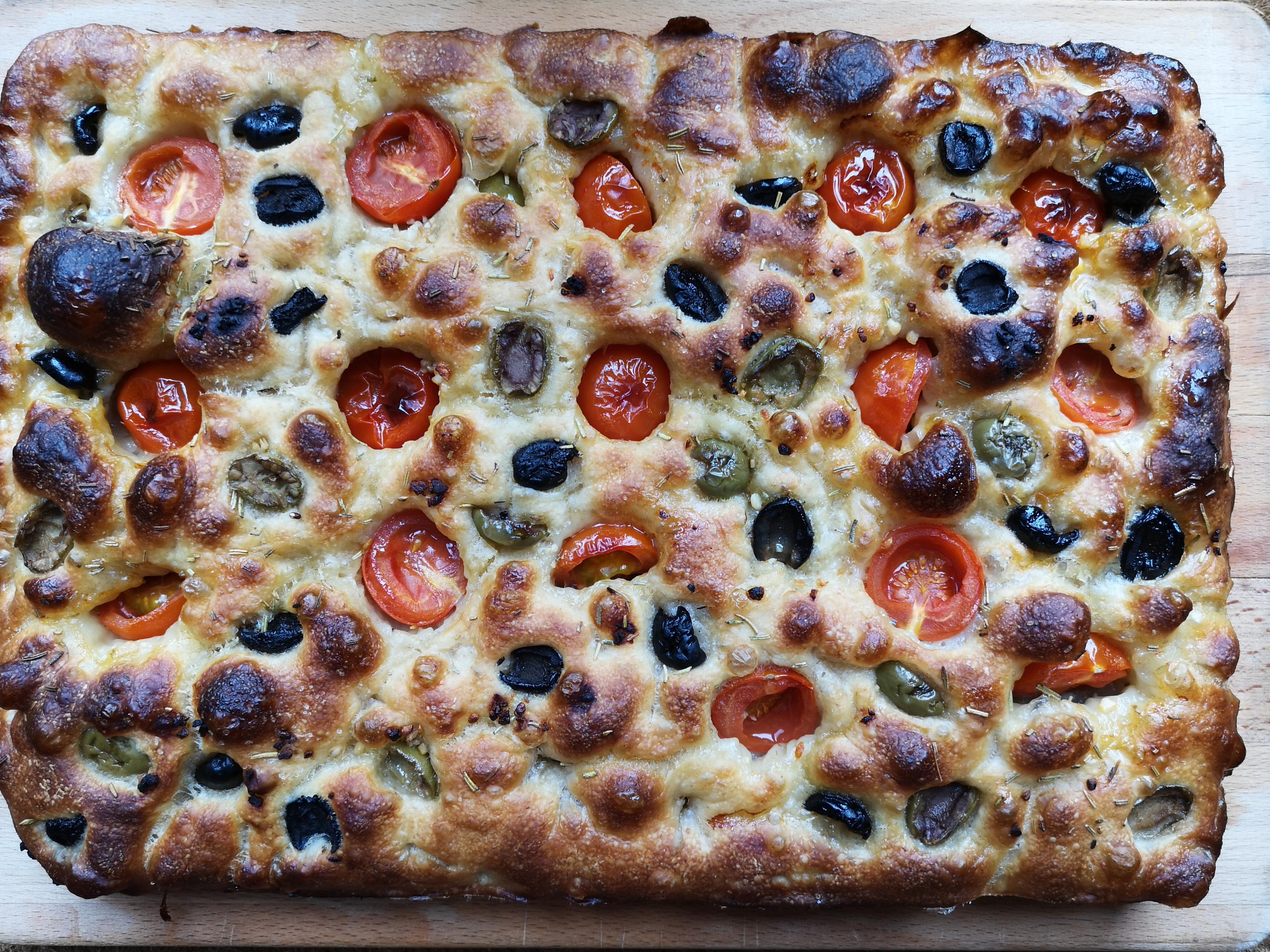 Sourdough focaccia topped with garlic, rosemary, cherry tomatoes