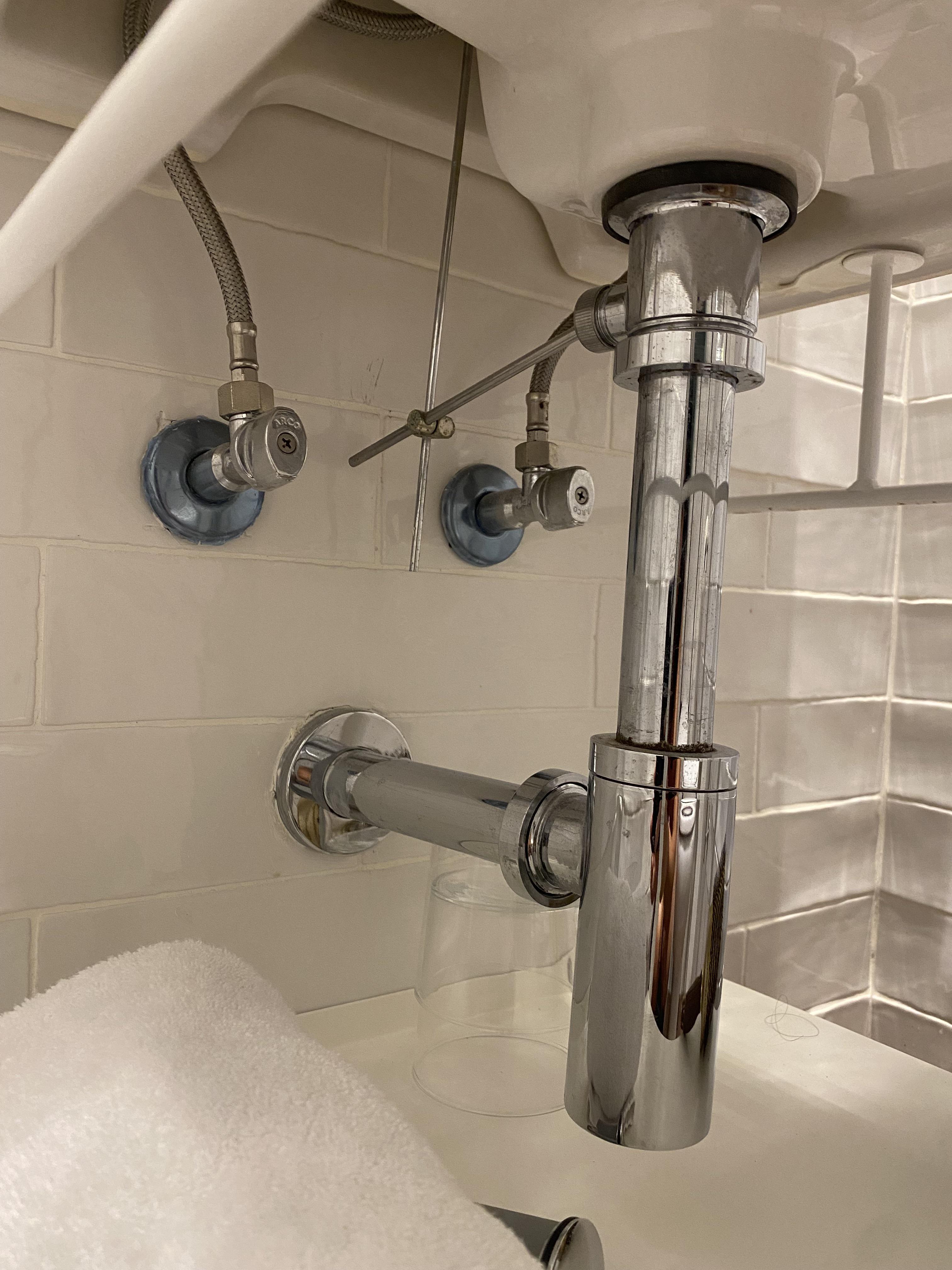 Help pearl earring fell down hotel sink. Can it be retrieved? Photo